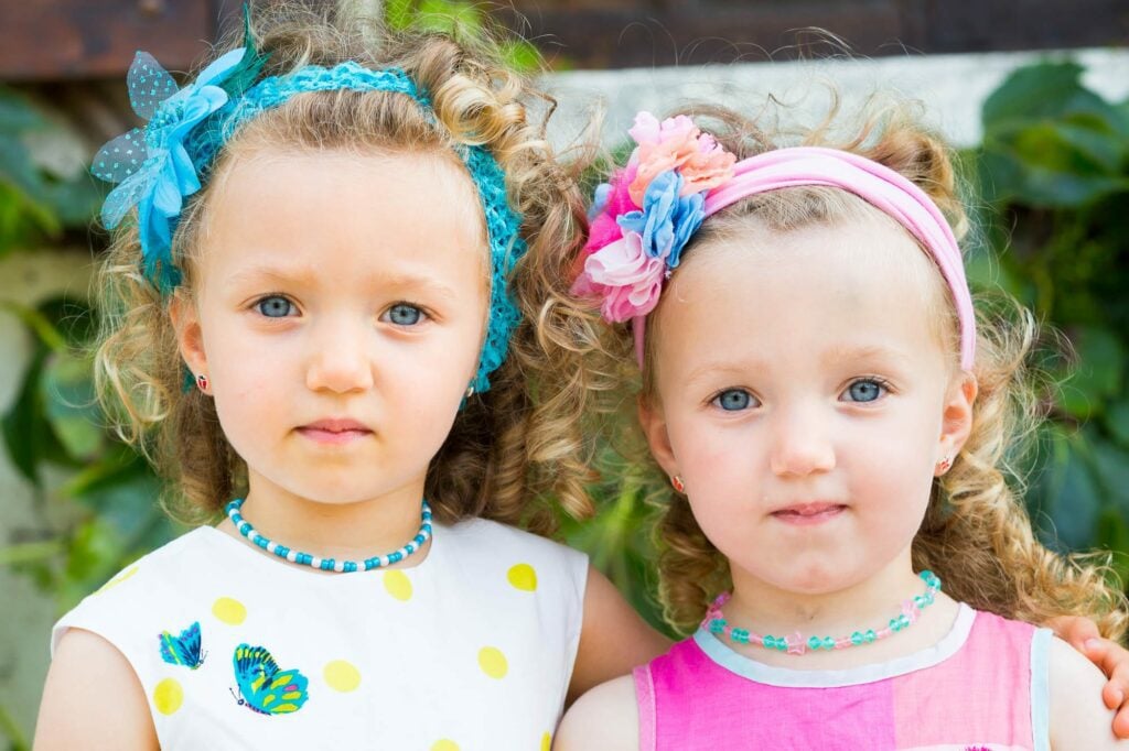 twin sisters flowergirls at wedding blue eyes