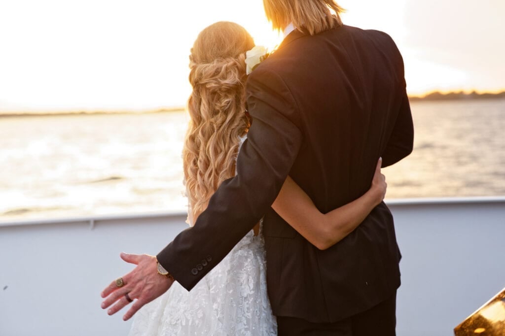 bride and groom boat sunset