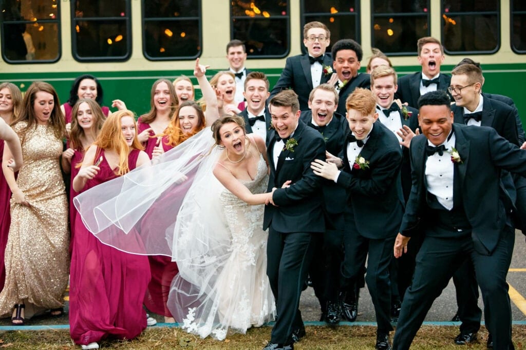 the bridal party running over the bride and groom