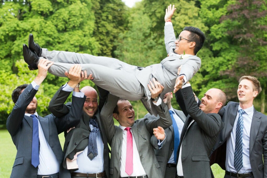 best friends carrying the groom