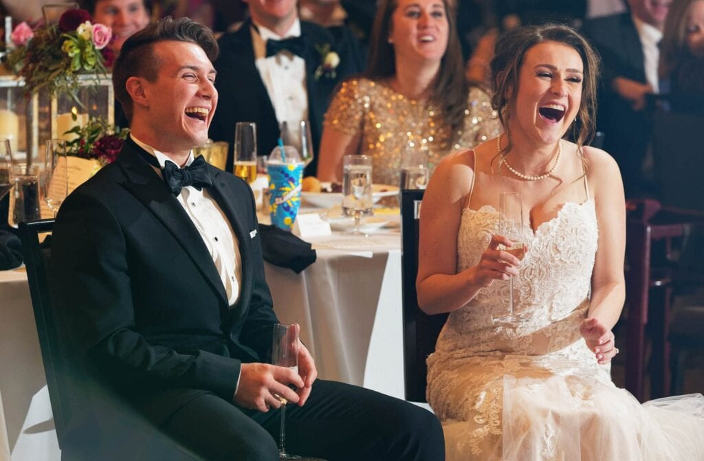 husband and wife laughing during speeches