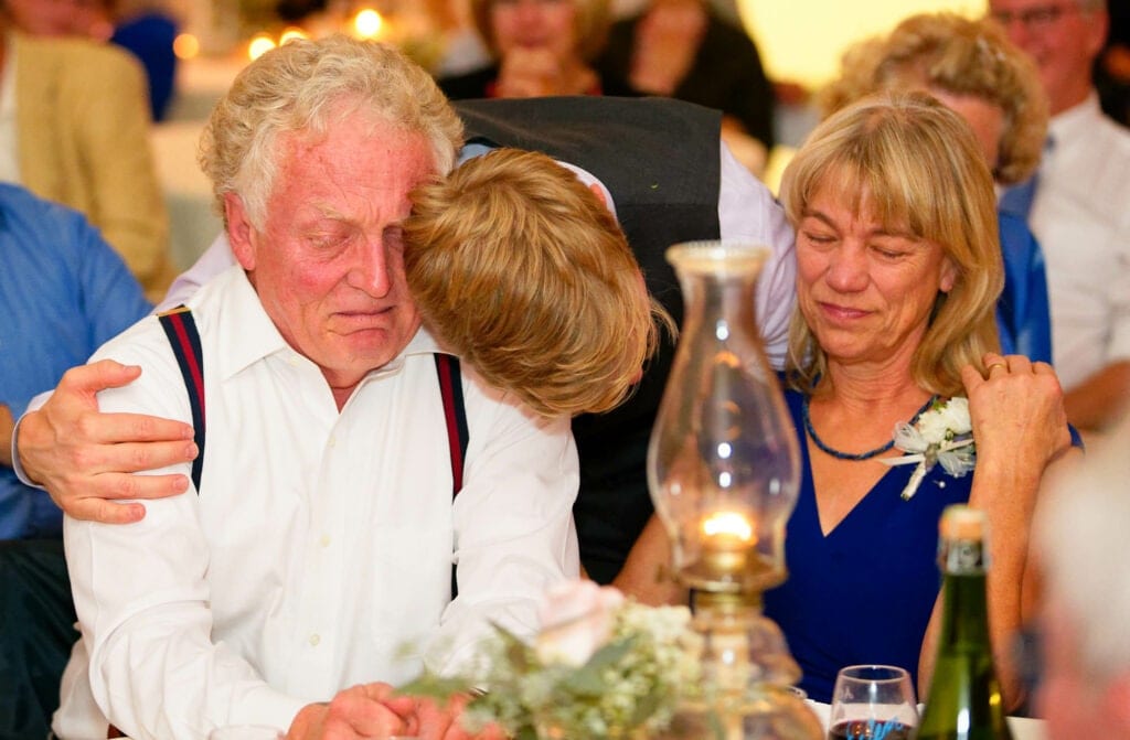 groom hugging his parents