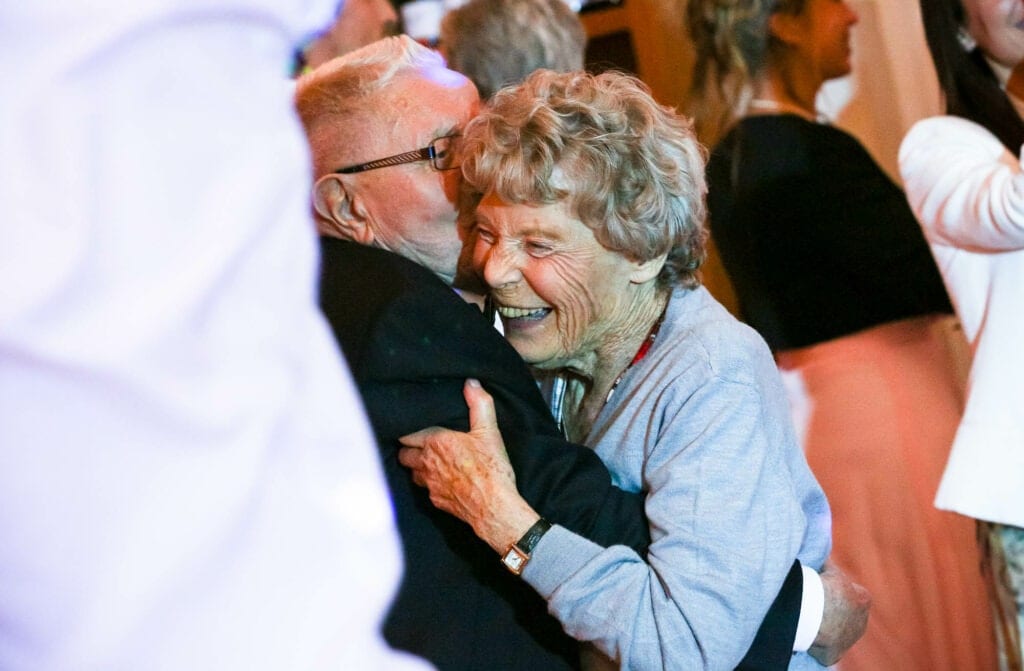 grandfather and grandmother dancing cheek to cheek