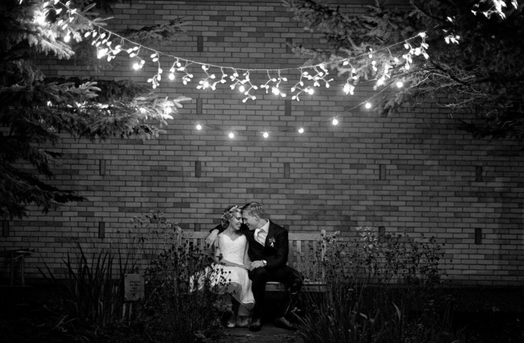 bride and groom on a bench