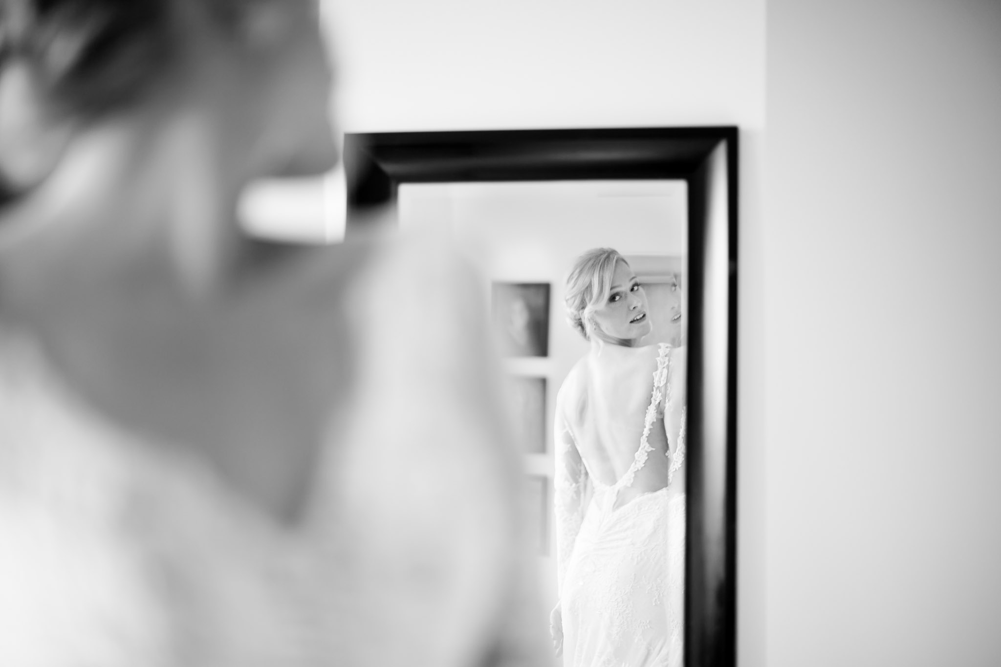 Bride Checking Wedding Dress in Mirror During Preparations