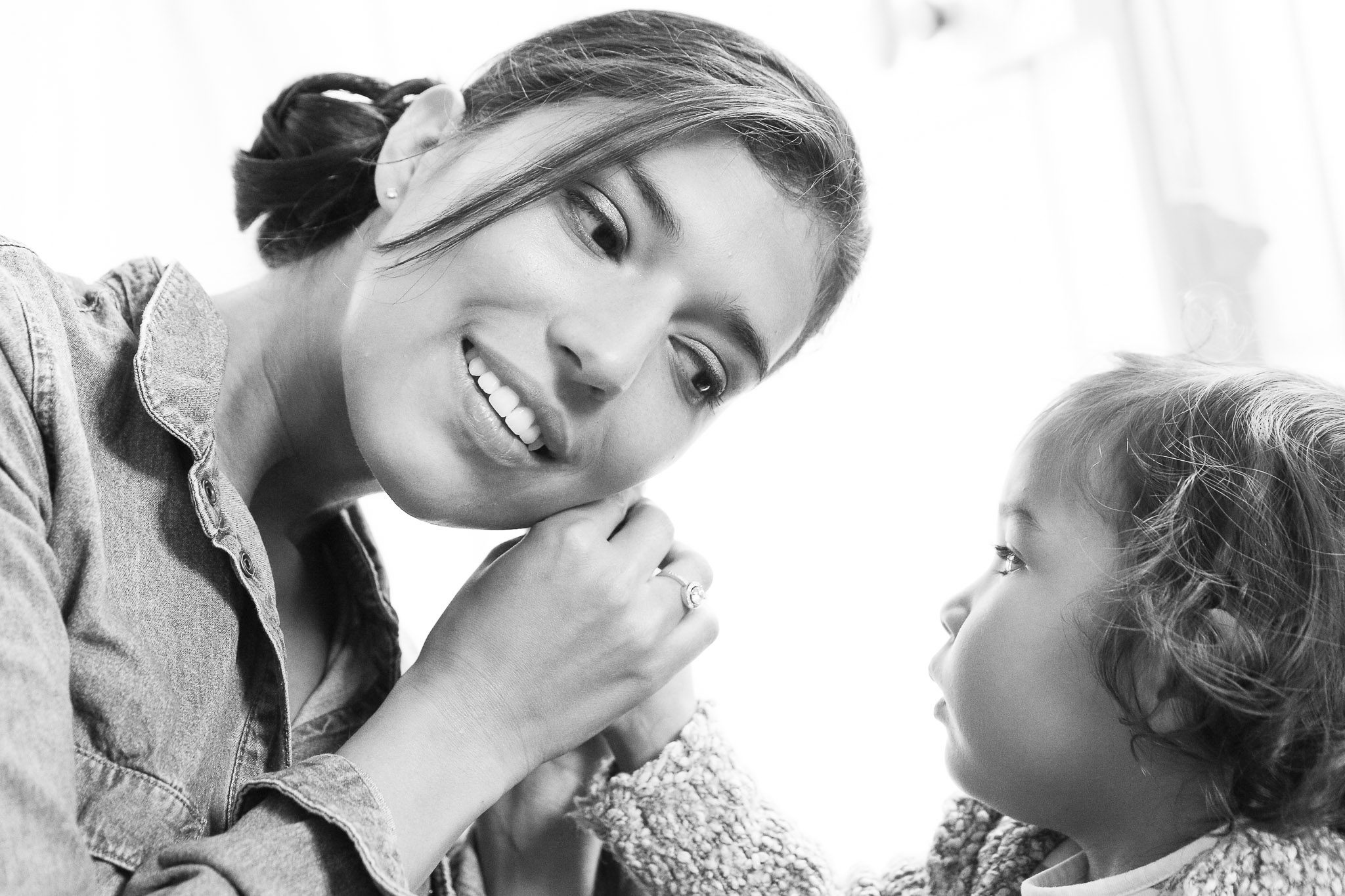 Child Helps with Hearing Aid During Wedding Preparations