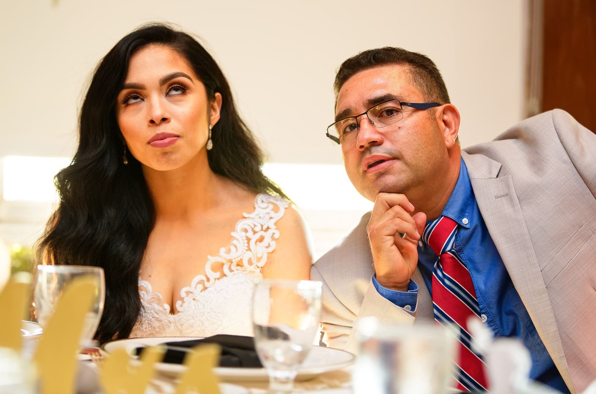 Bride Rolling Eyes During Father Photo at Wedding Reception