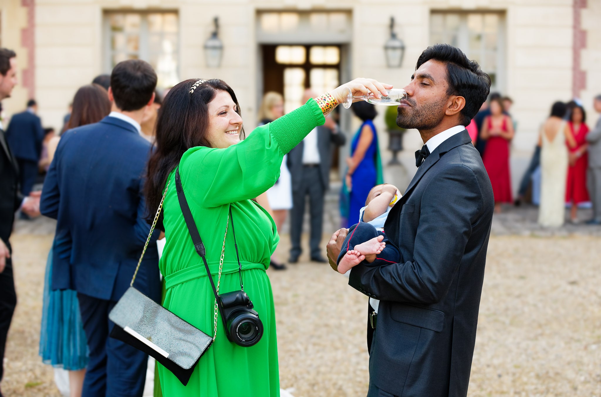 Wedding Guests Share Champagne During Cocktail Hour Reception