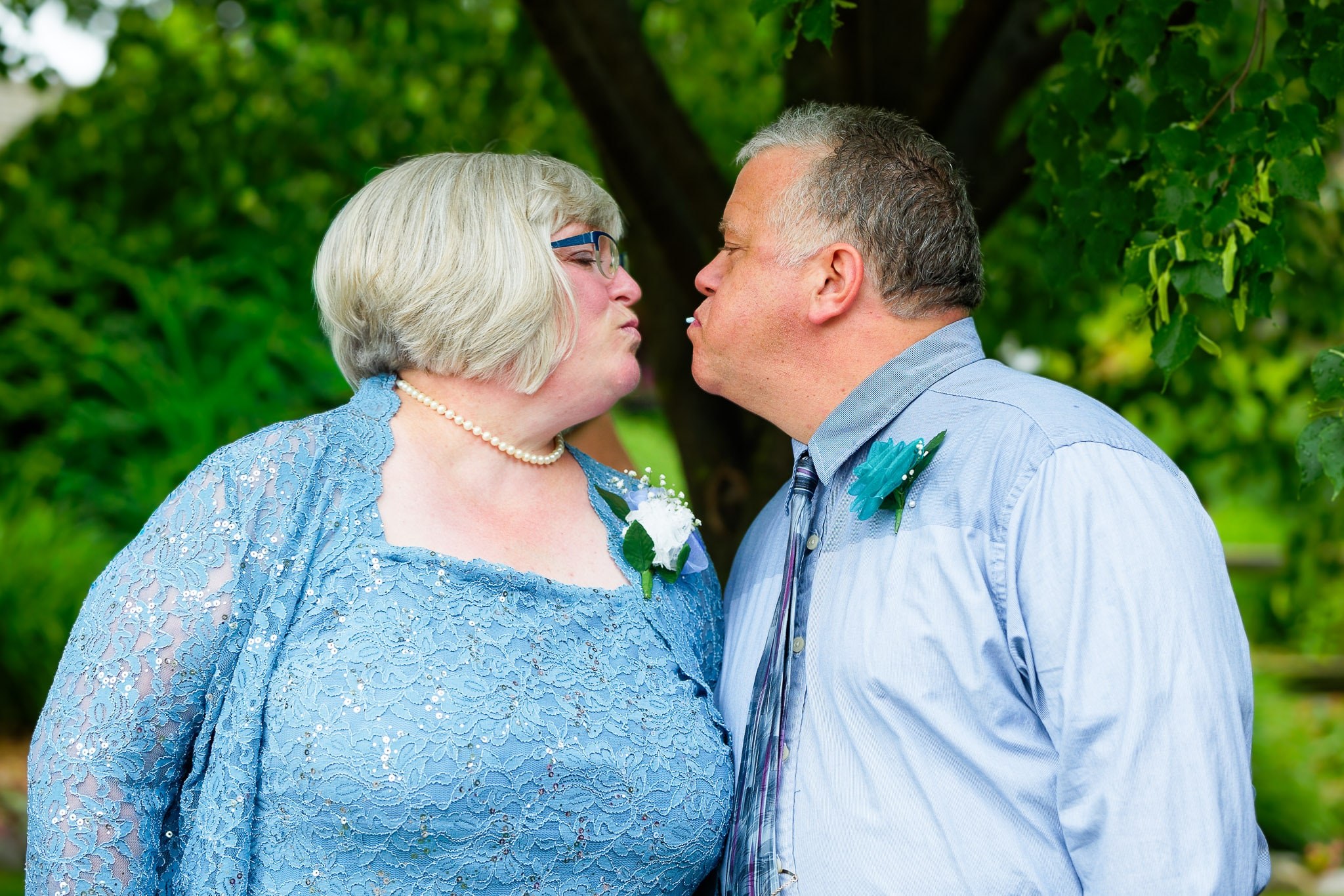 Groom's Parents Playful Kiss During Wedding Ceremony
