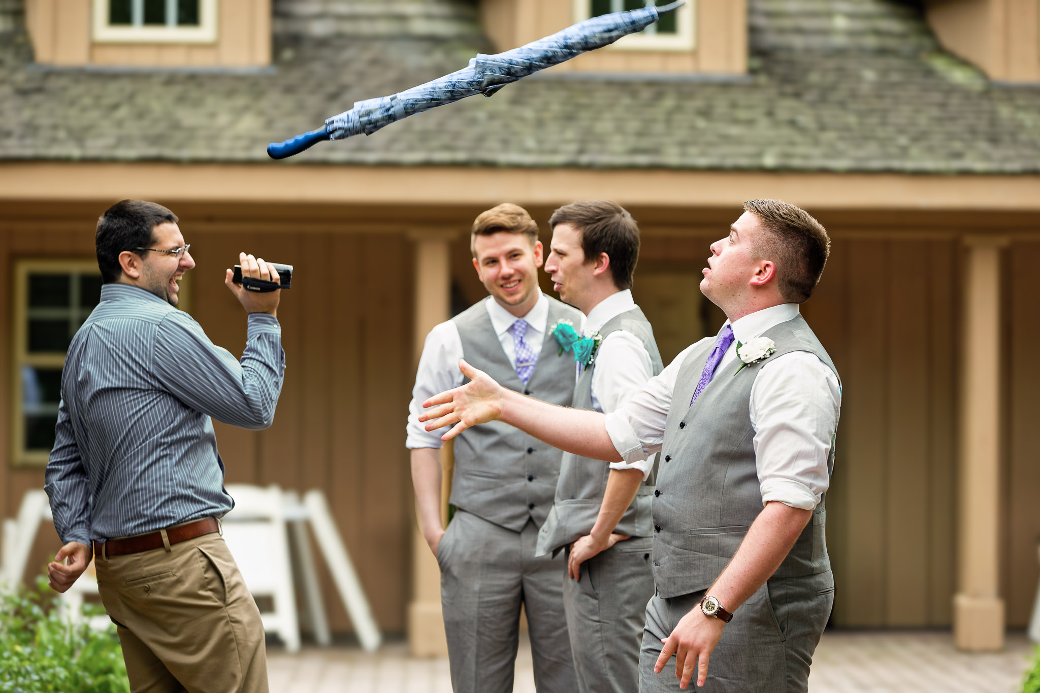 Groomsmen Watch Flying Cane During Wedding Celebration