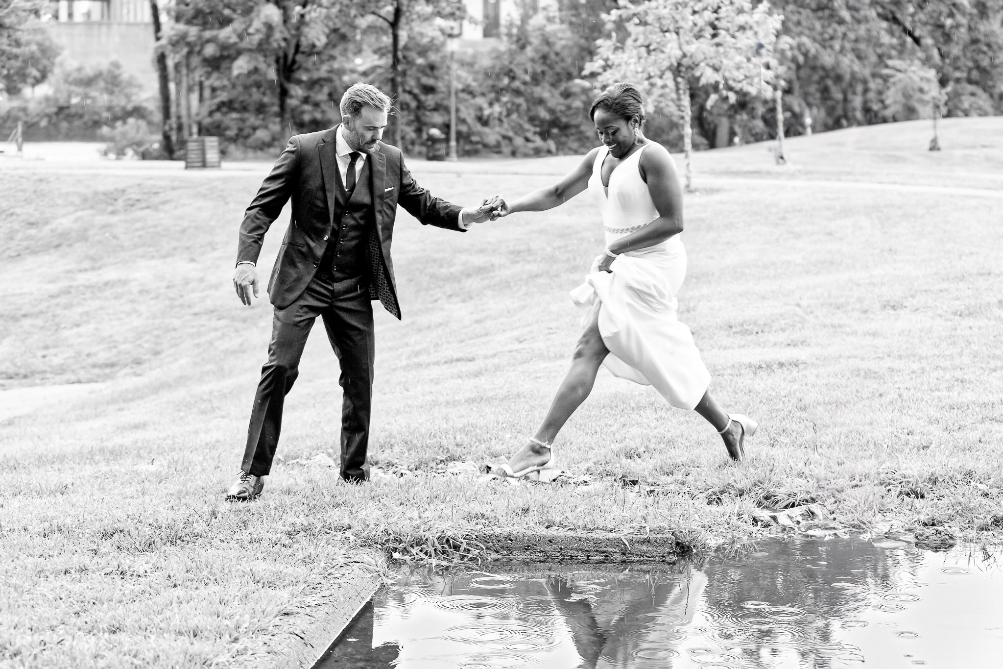 Bride Jumping Over Puddle Wedding Photo