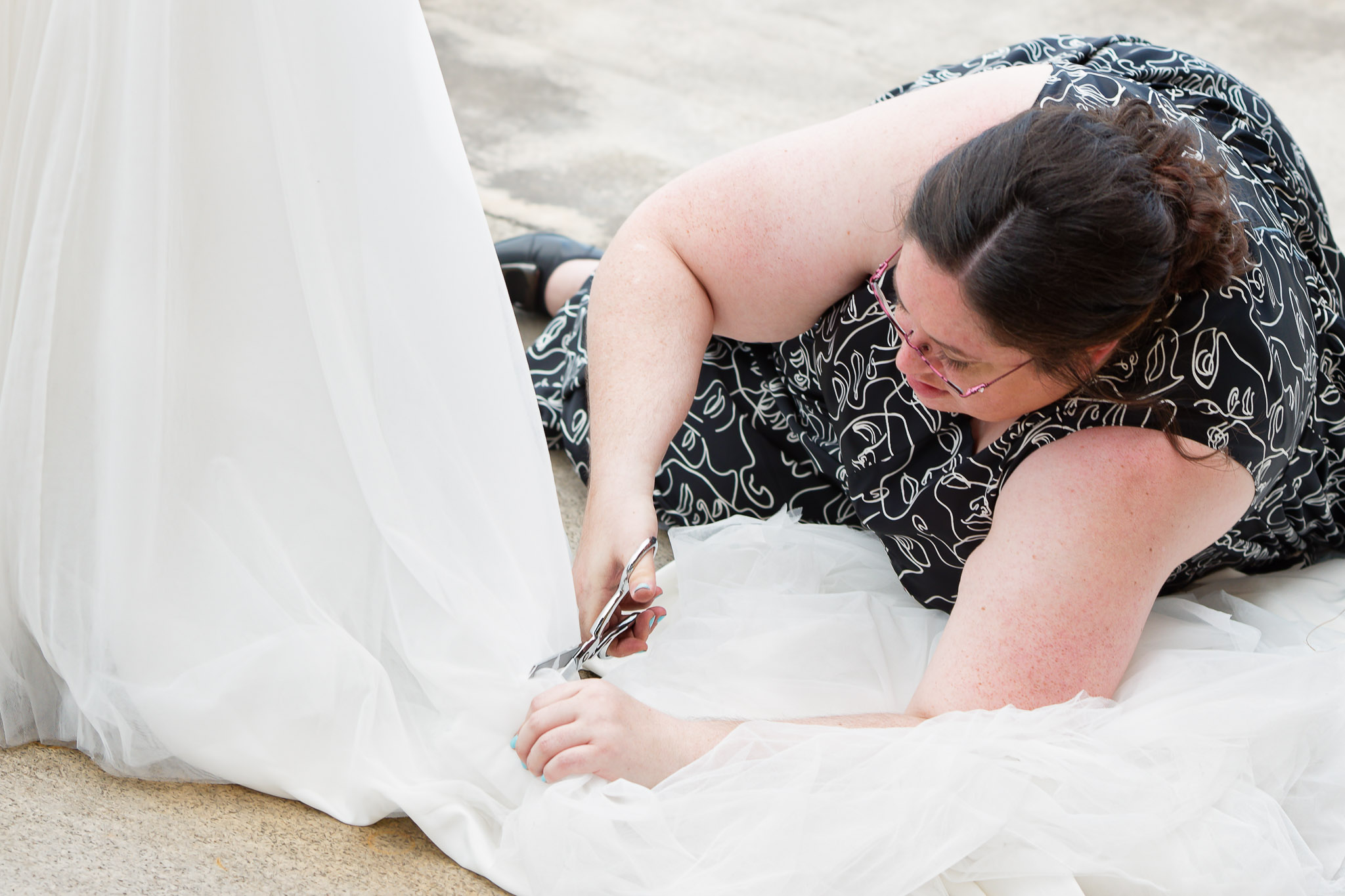 Guest Cutting Bride's Dress During Minneapolis Wedding Reception