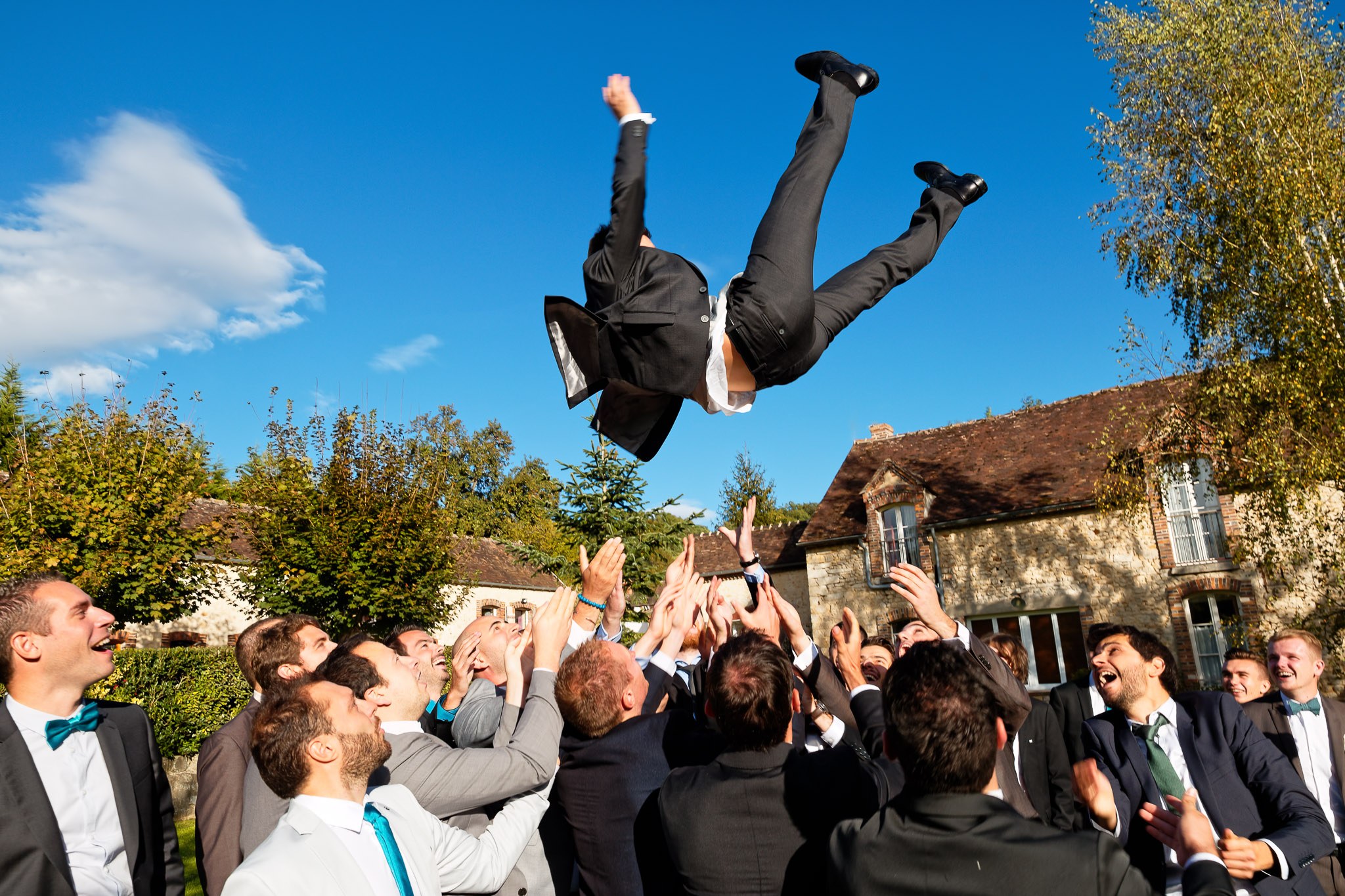 Groom Tossed in Air by Wedding Party - Reception Celebration