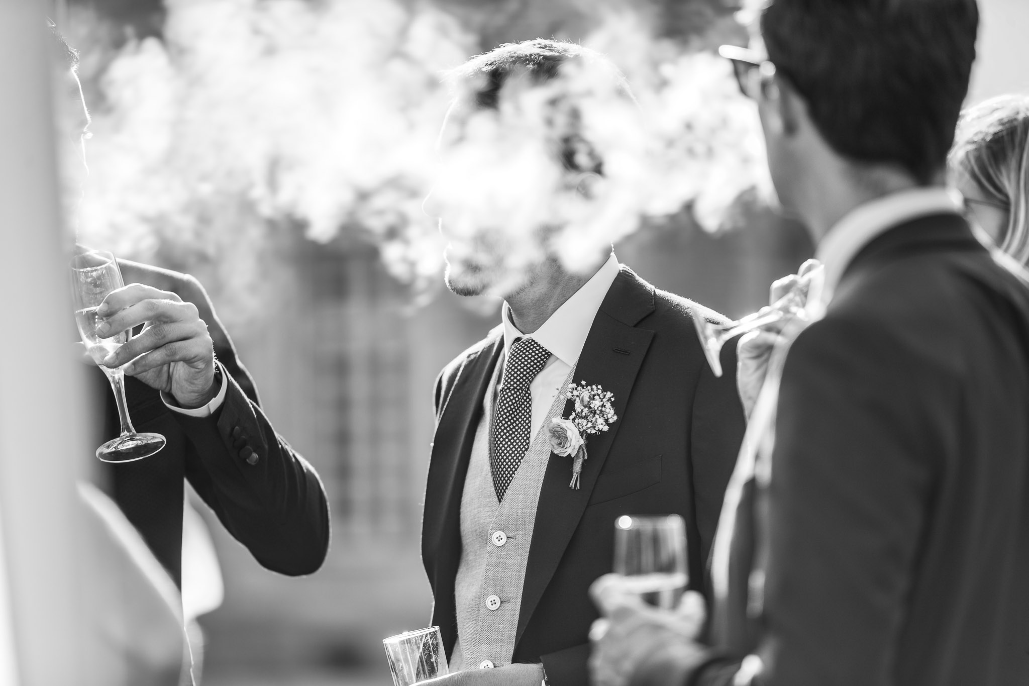 Groomsmen Smoking Cigars During Wedding Cocktail Hour