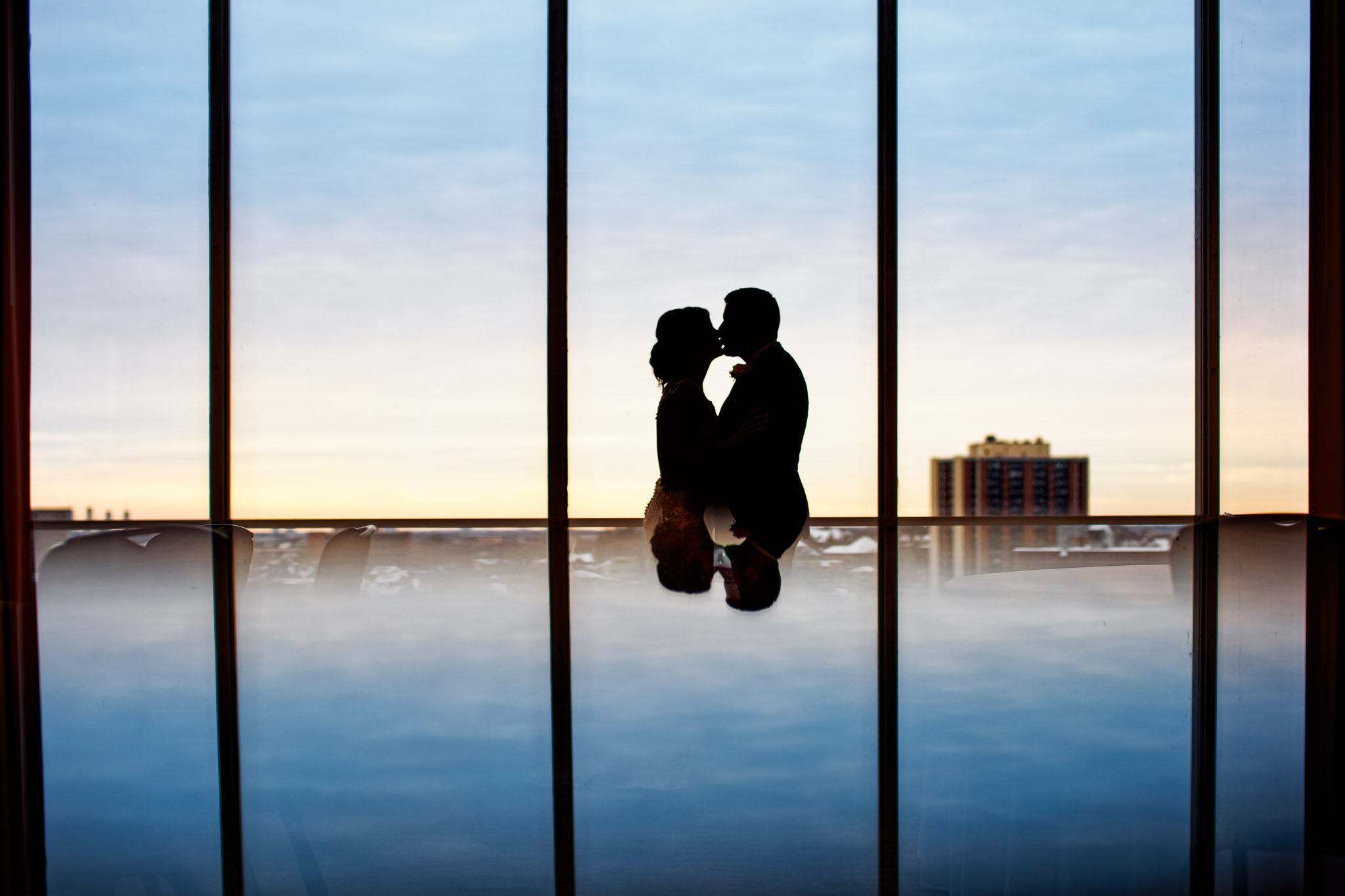 Bride and Groom Silhouette Kiss with Sky Reflection