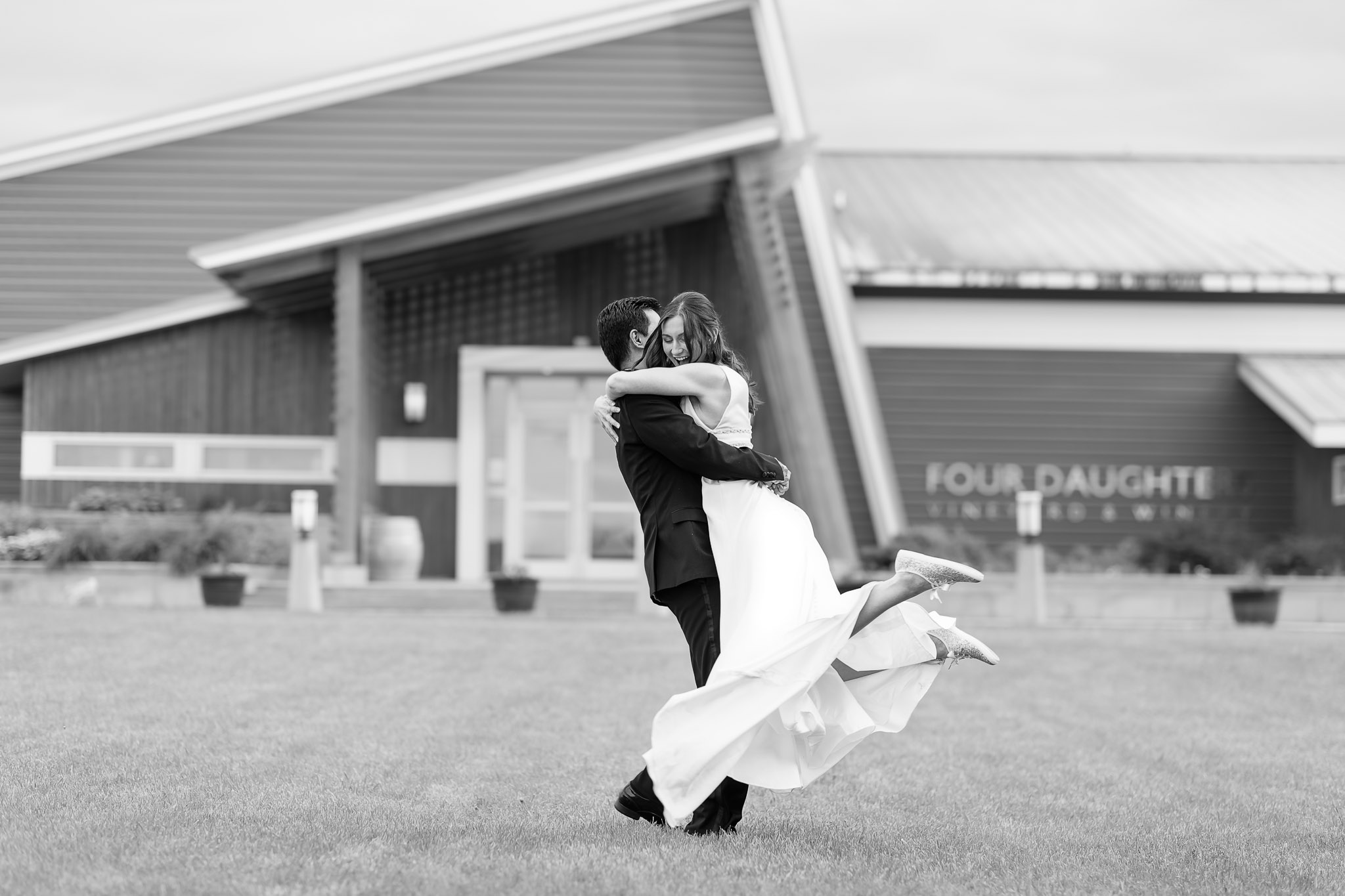 Groom Lifts Bride at Four Daughters Vineyard Wedding Reception