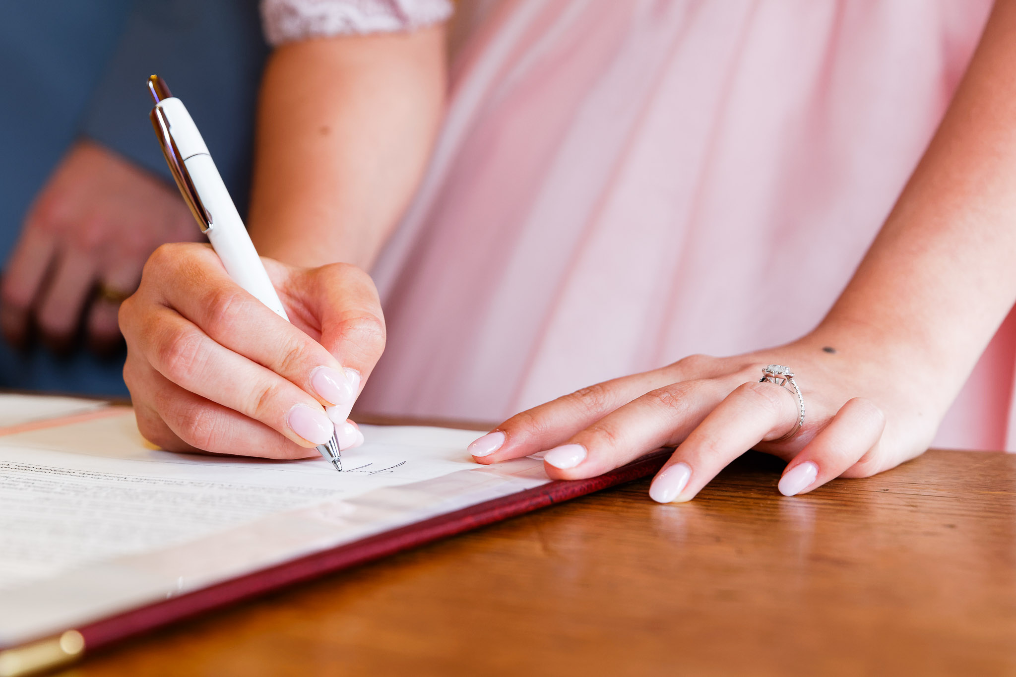 Bride Signing Wedding Certificate at Courthouse Ceremony
