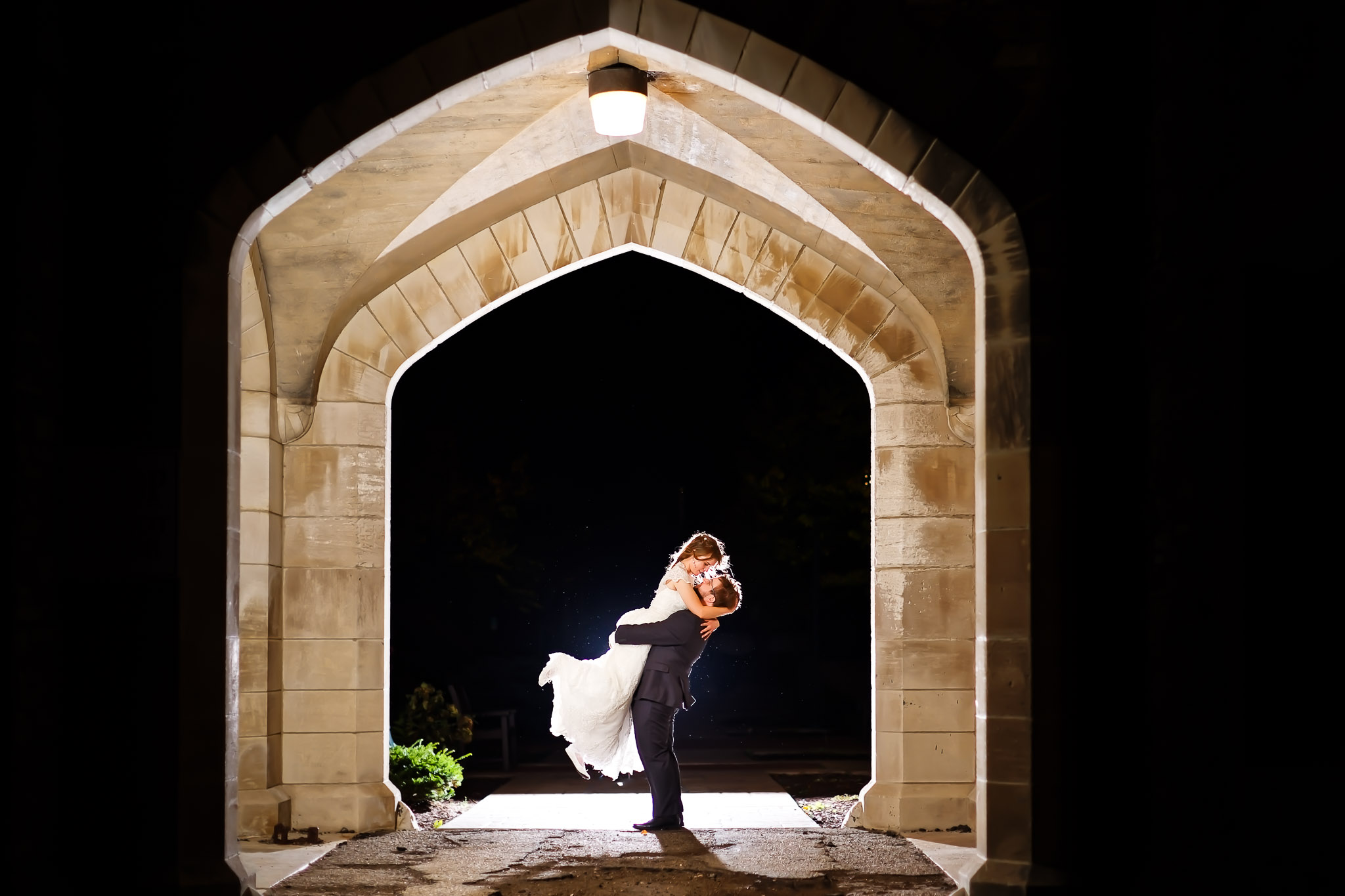 Creative Flash Wedding Photography Under Stone Arch