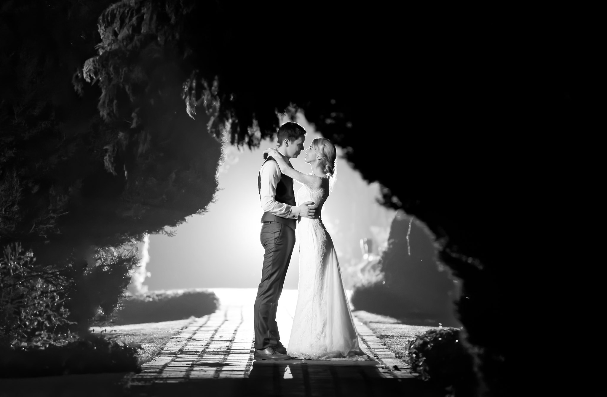 Creative Nighttime Wedding Portrait with Dramatic Lighting