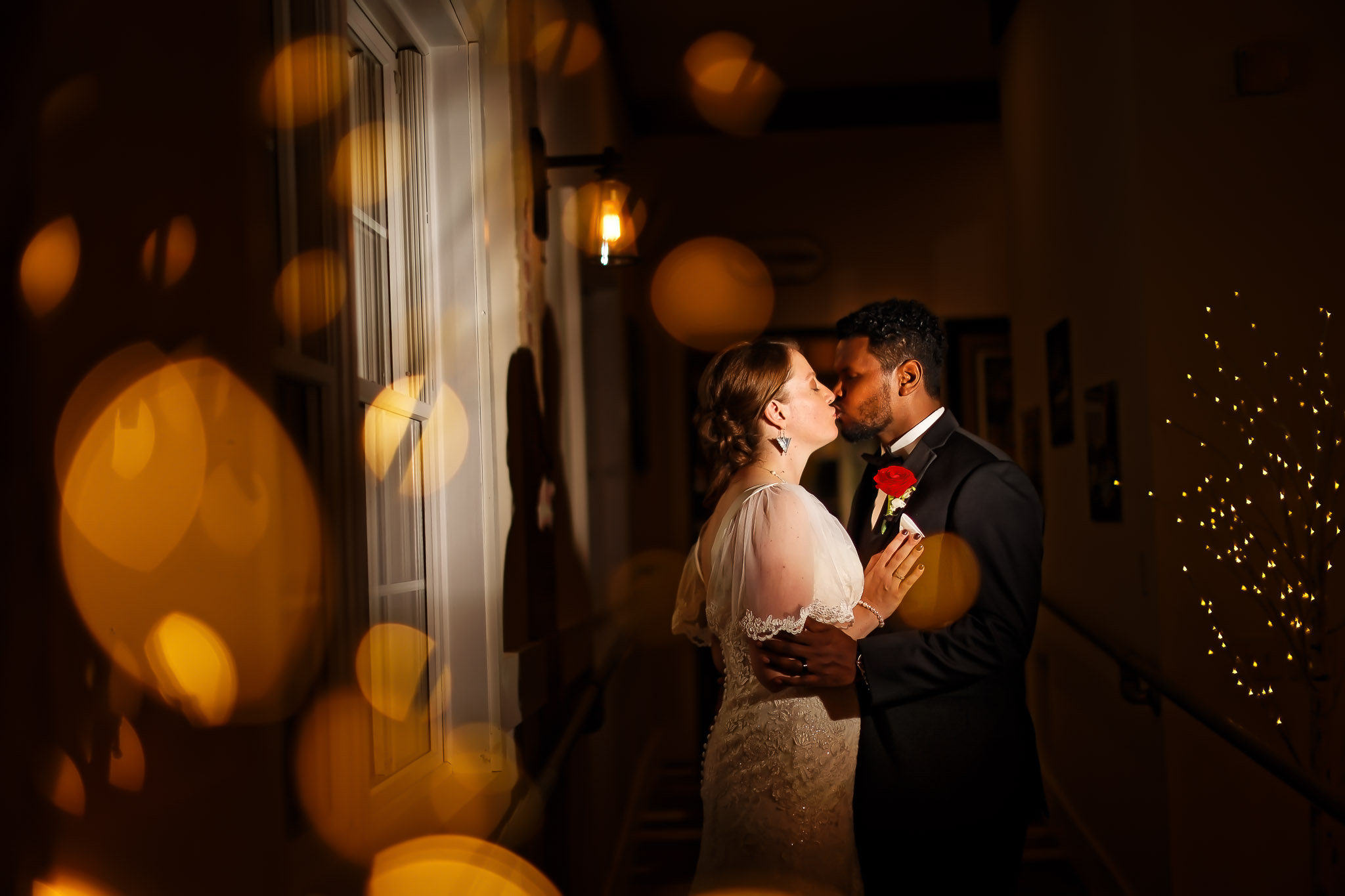 Romantic Hallway Kiss with Fairy Lights - Byron MN Wedding
