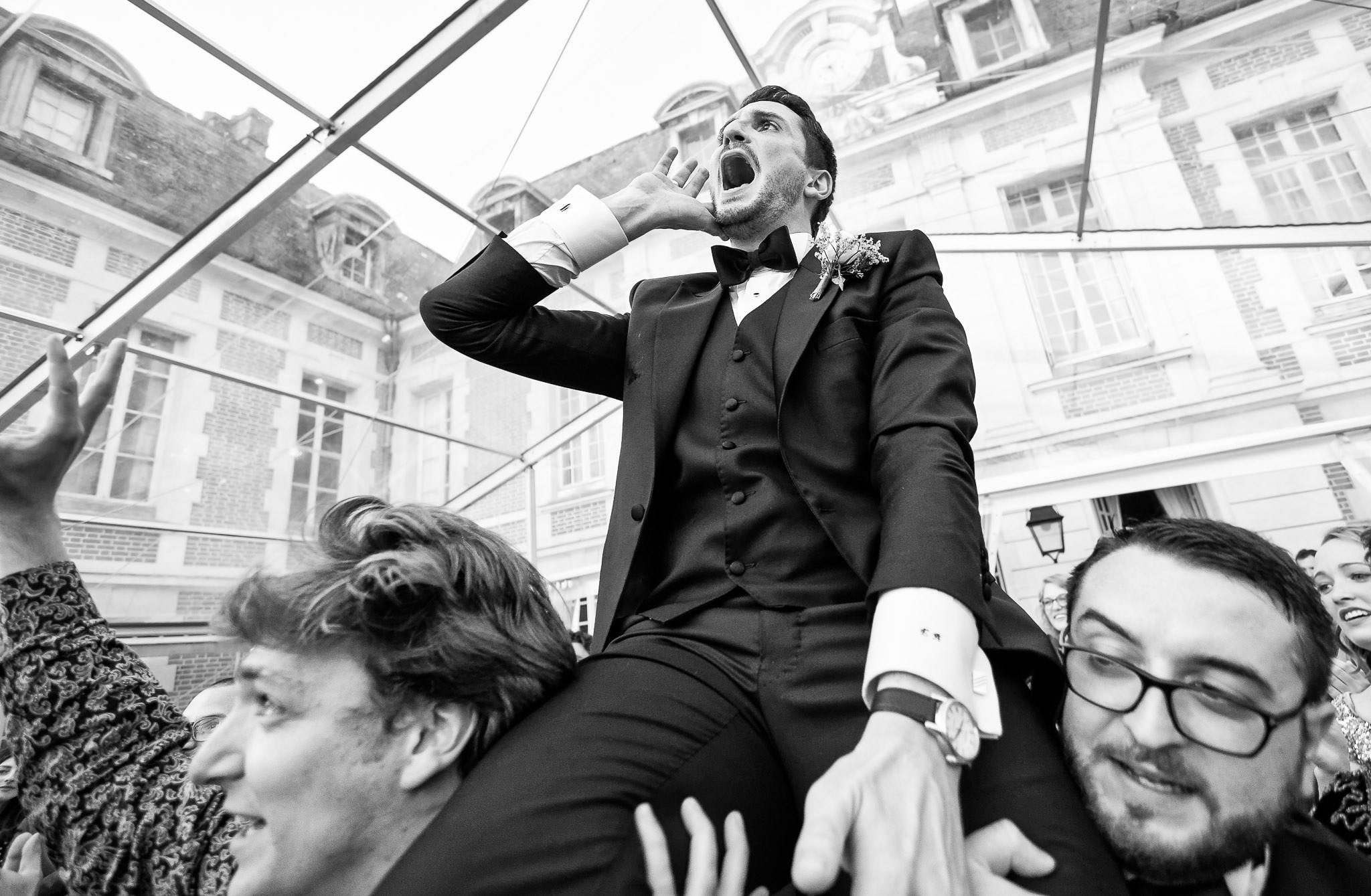 Groom Carried by Friends During Wedding Reception Party