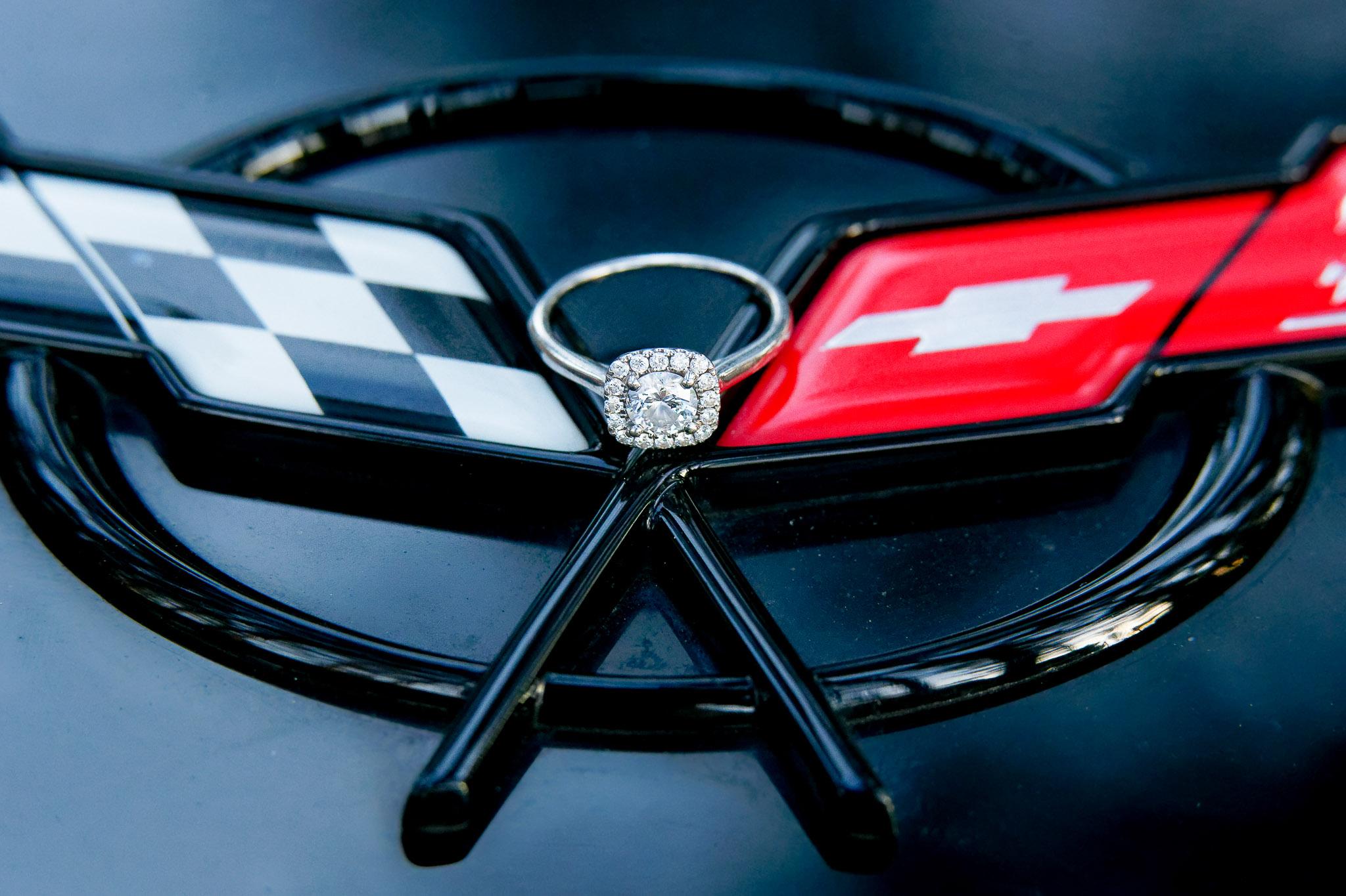 Diamond Engagement Ring on Corvette Emblem Detail Shot