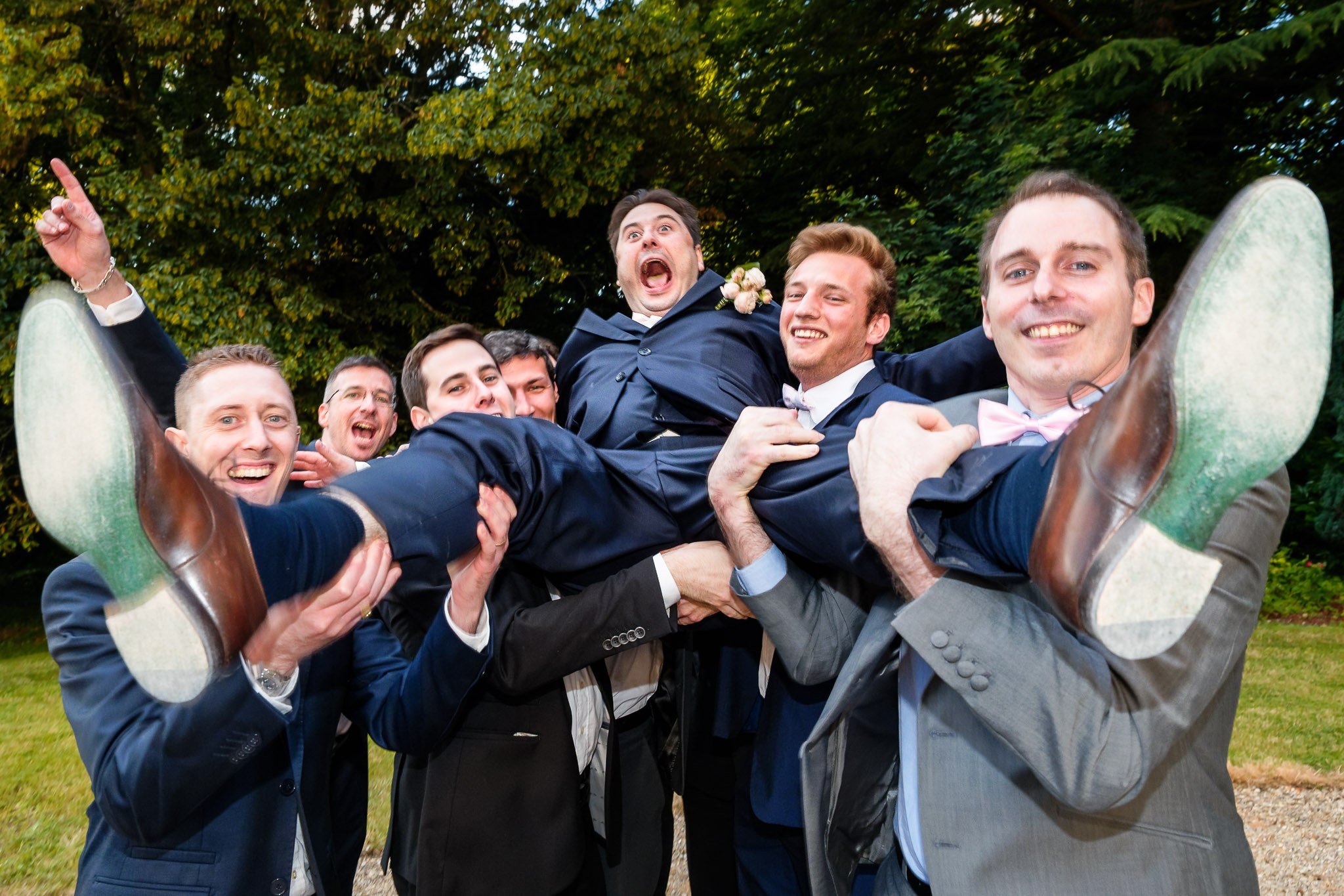 Groomsmen Lift Excited Groom During Fun Wedding Moment