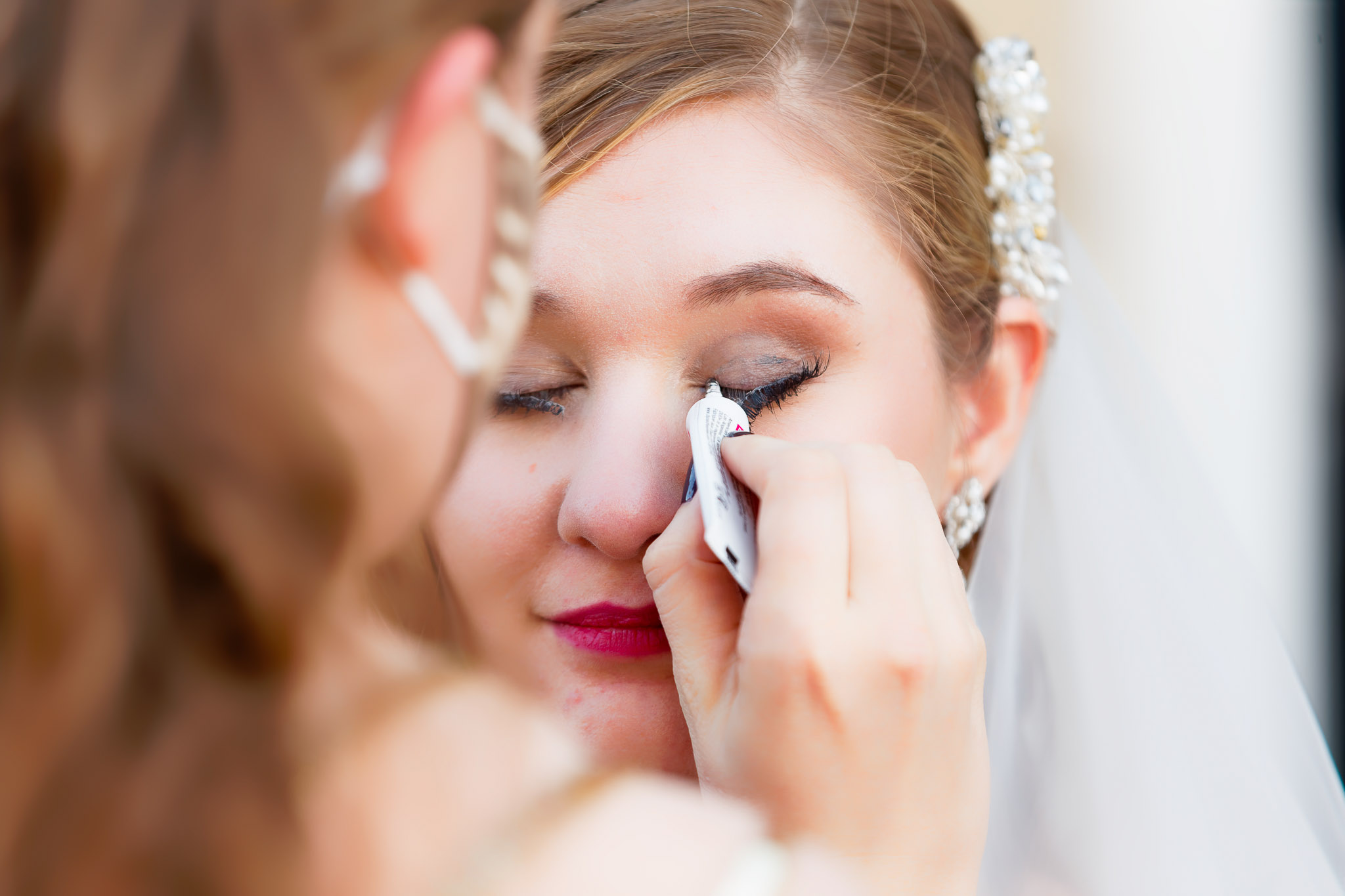 Guest Helps Bride Fix Unglued False Eyelash at Wedding