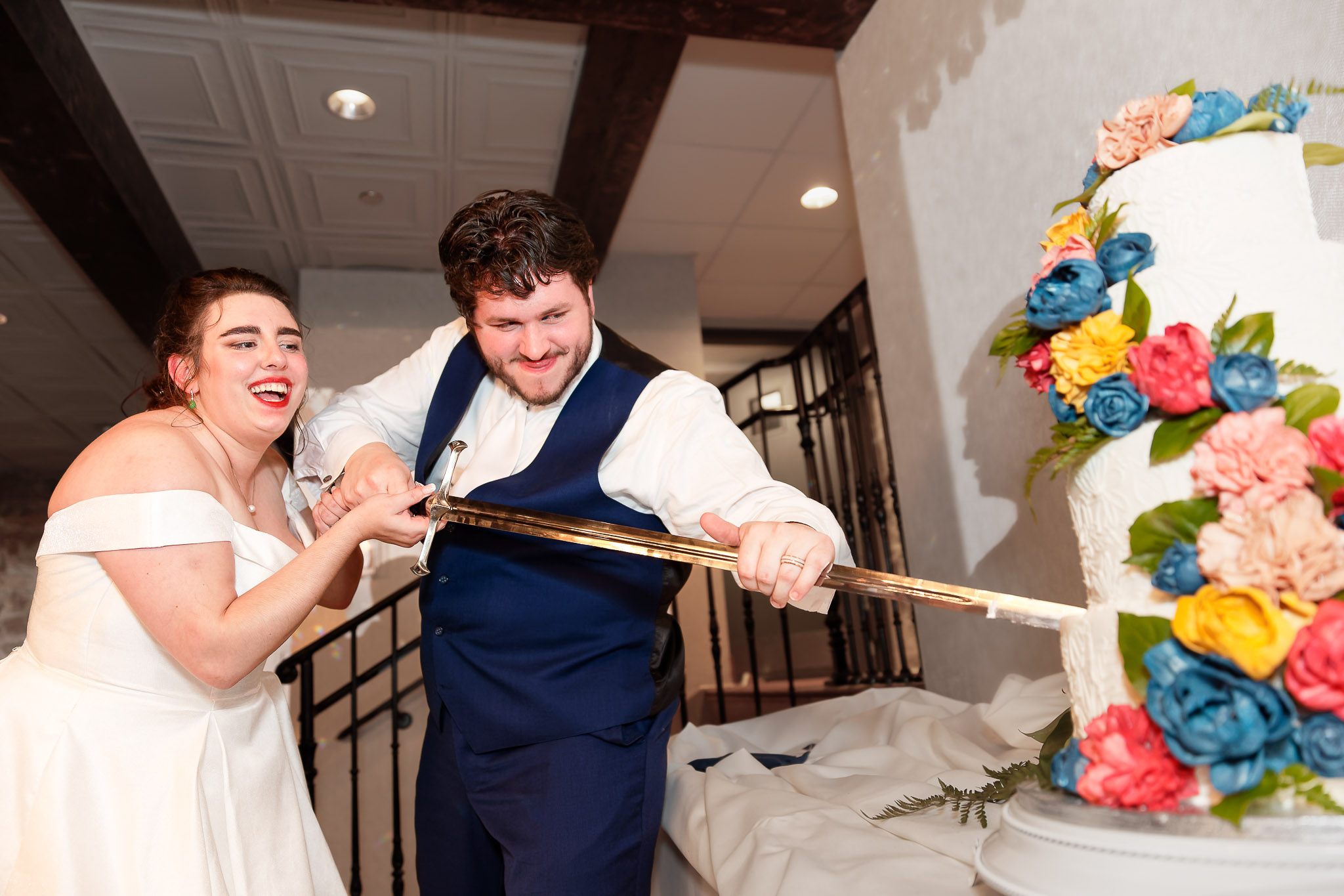 Bride and Groom Cut Wedding Cake with Sword - Minneapolis Weddin