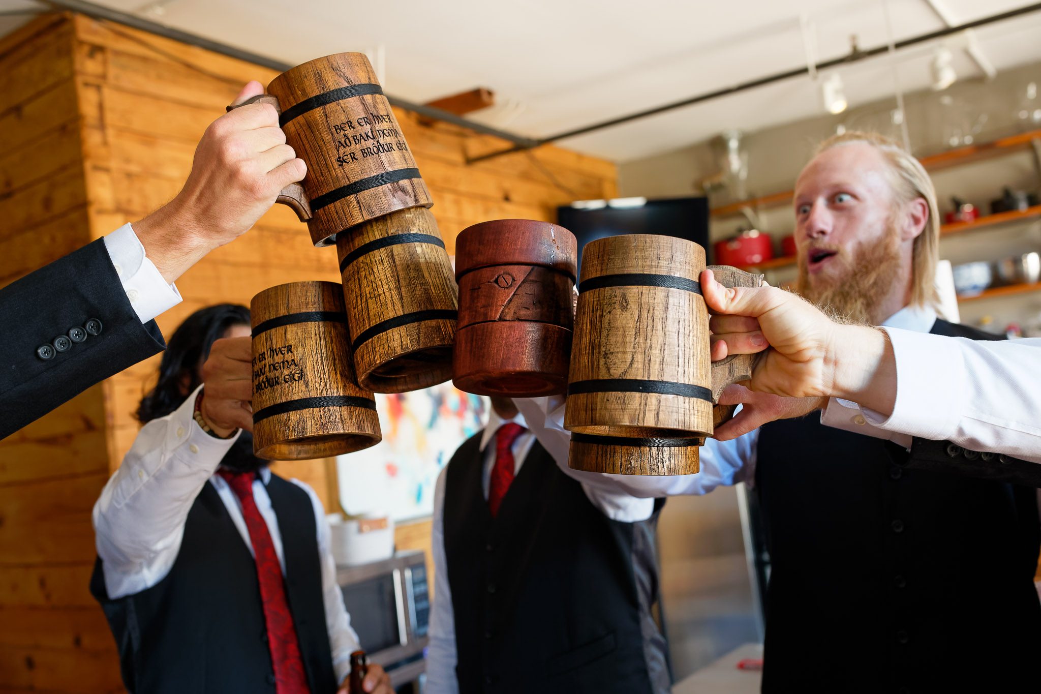 Groomsmen Toast with Wooden Beer Steins Before Wedding