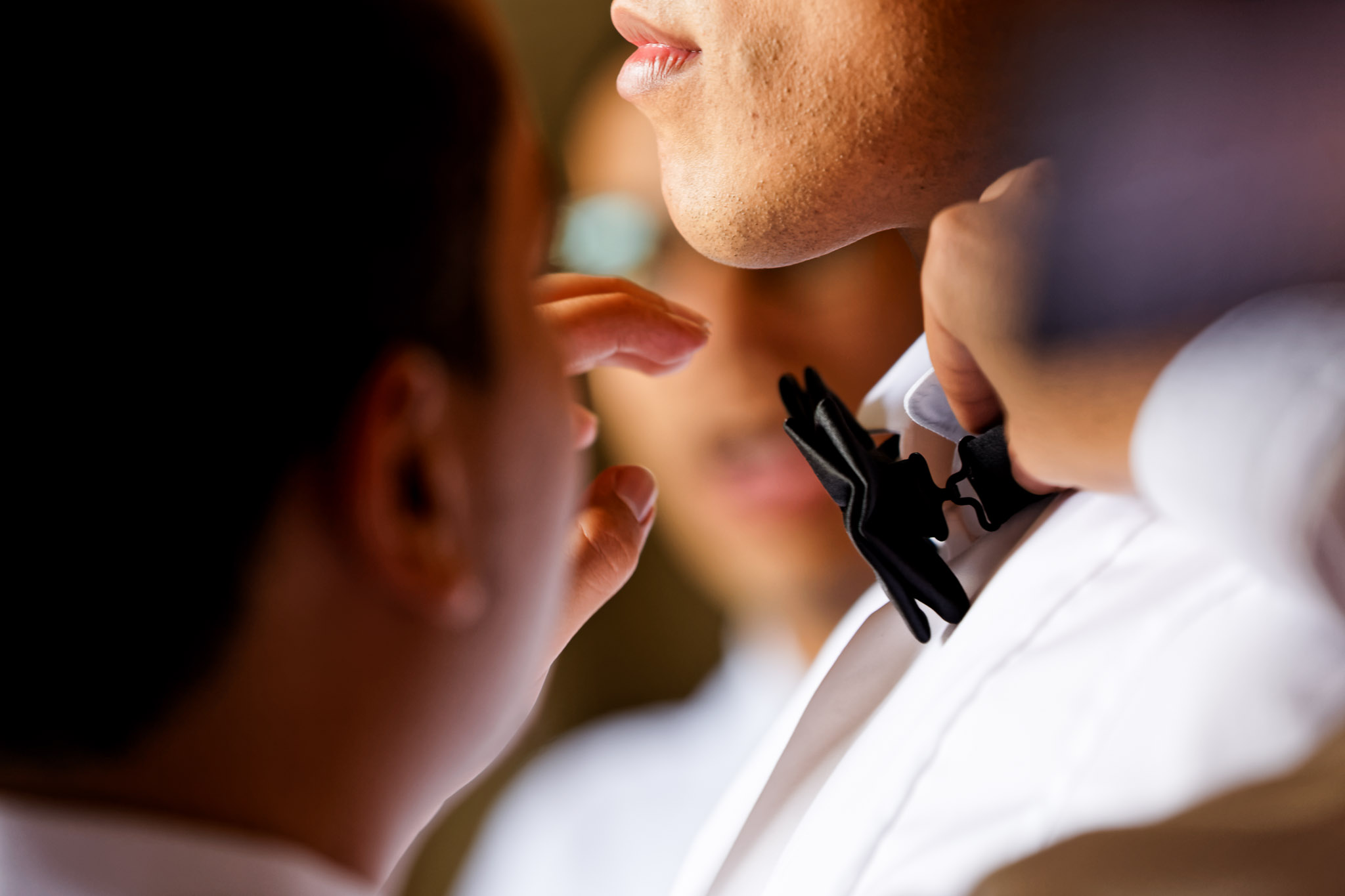 Groomsman Helping Groom Fix Bow Tie Wedding Preparation