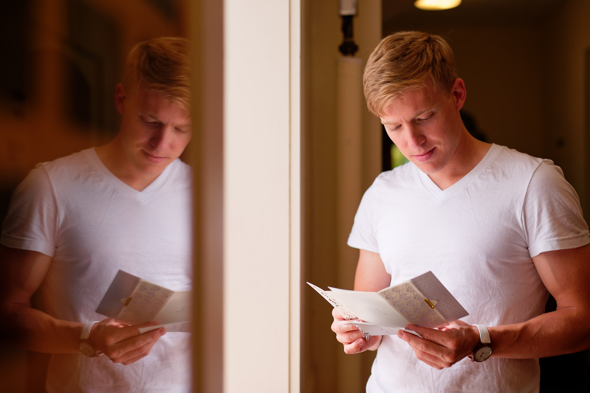 Groom Reading Bride's Letter During Wedding Preparation