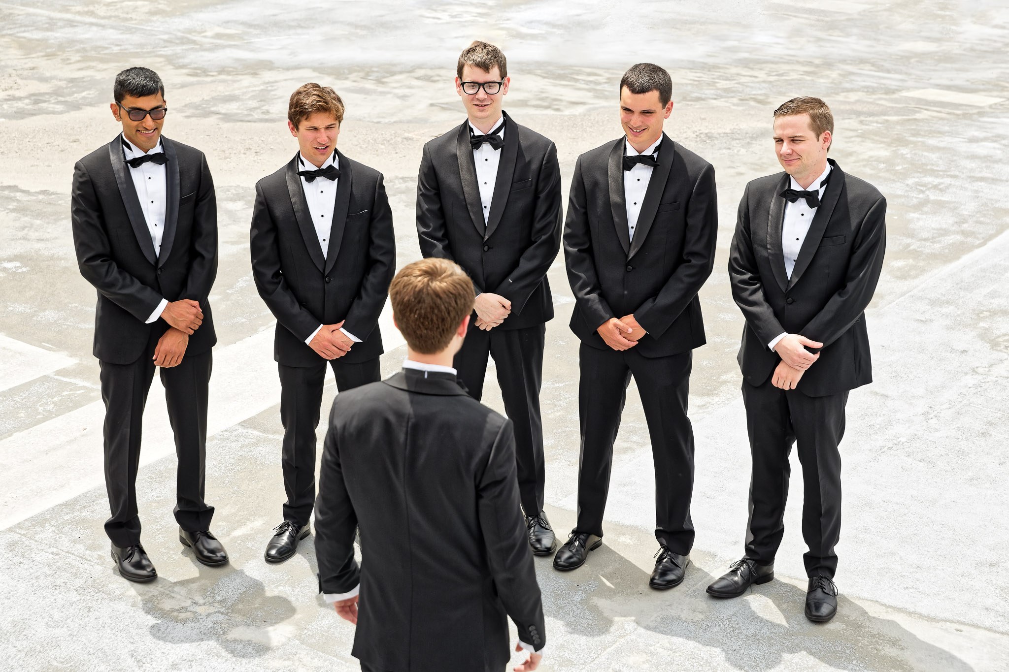 Groom Inspecting Groomsmen Wedding Preparation Photo