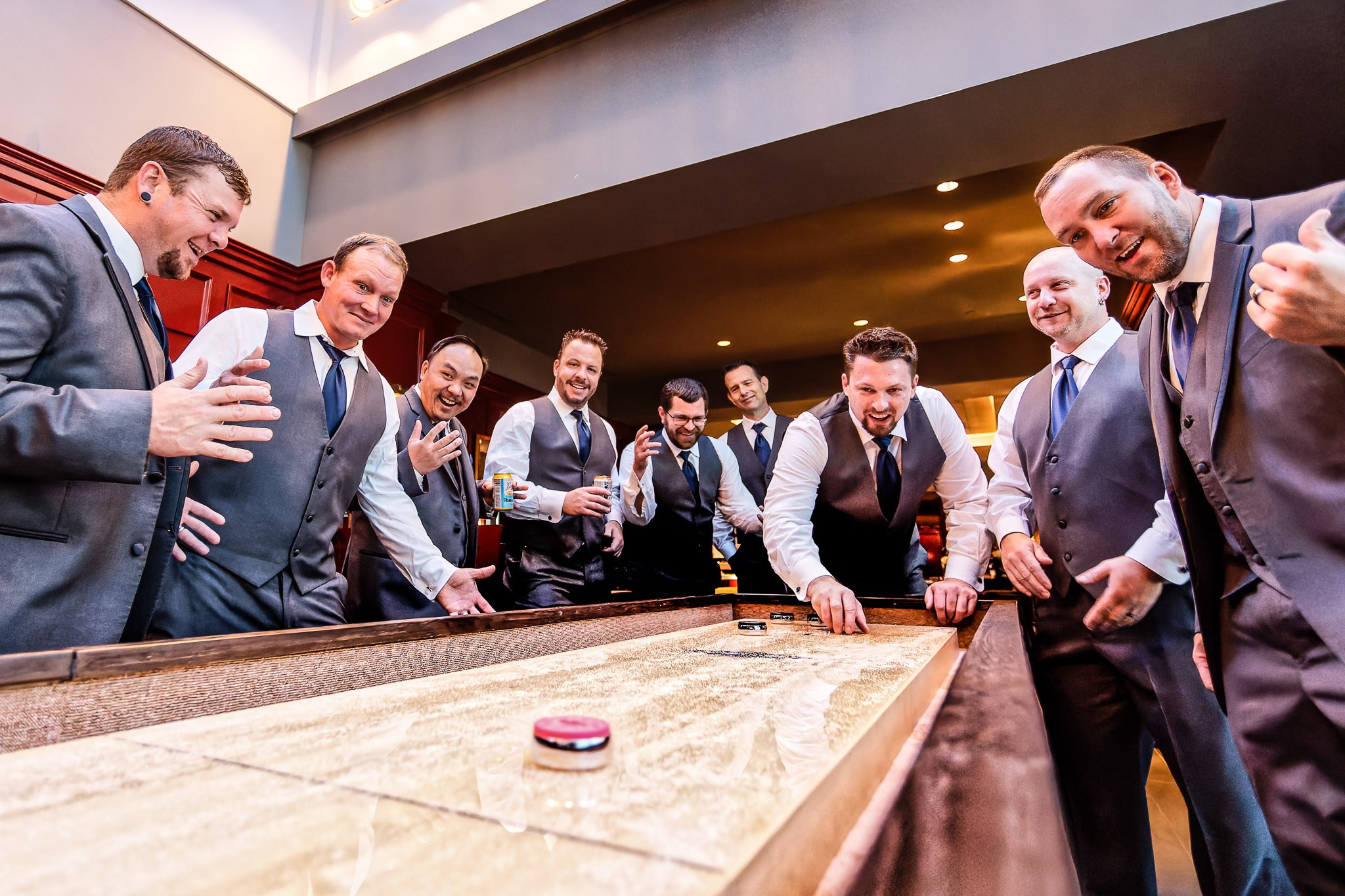 Groom and Groomsmen Playing Shuffleboard Wedding Preparations