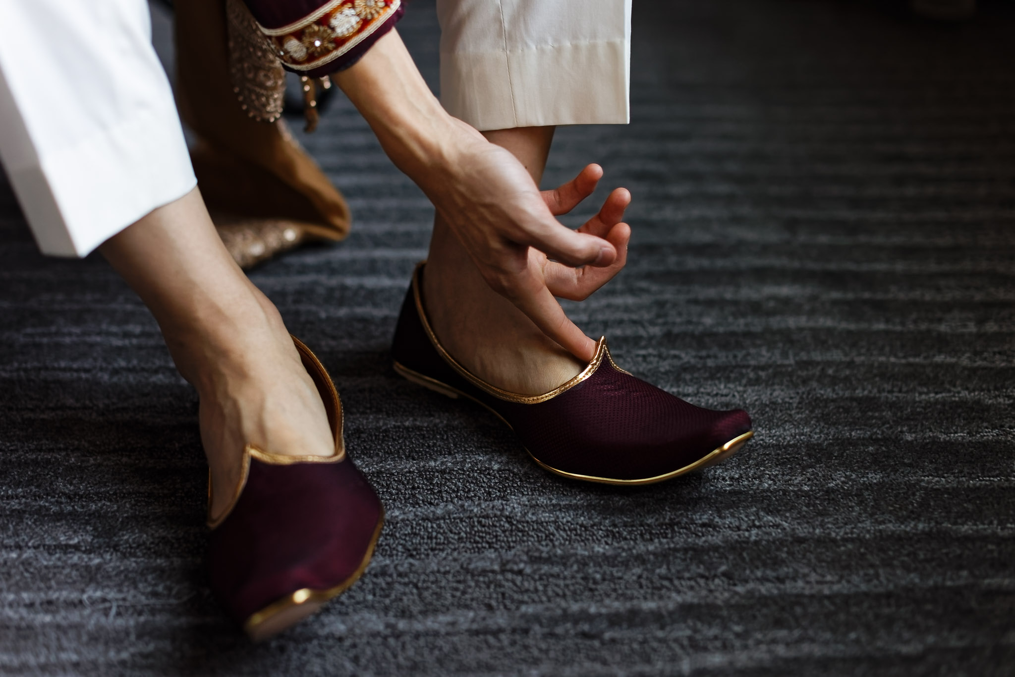 Groom Putting On Indian Wedding Shoes - Bloomington Wedding