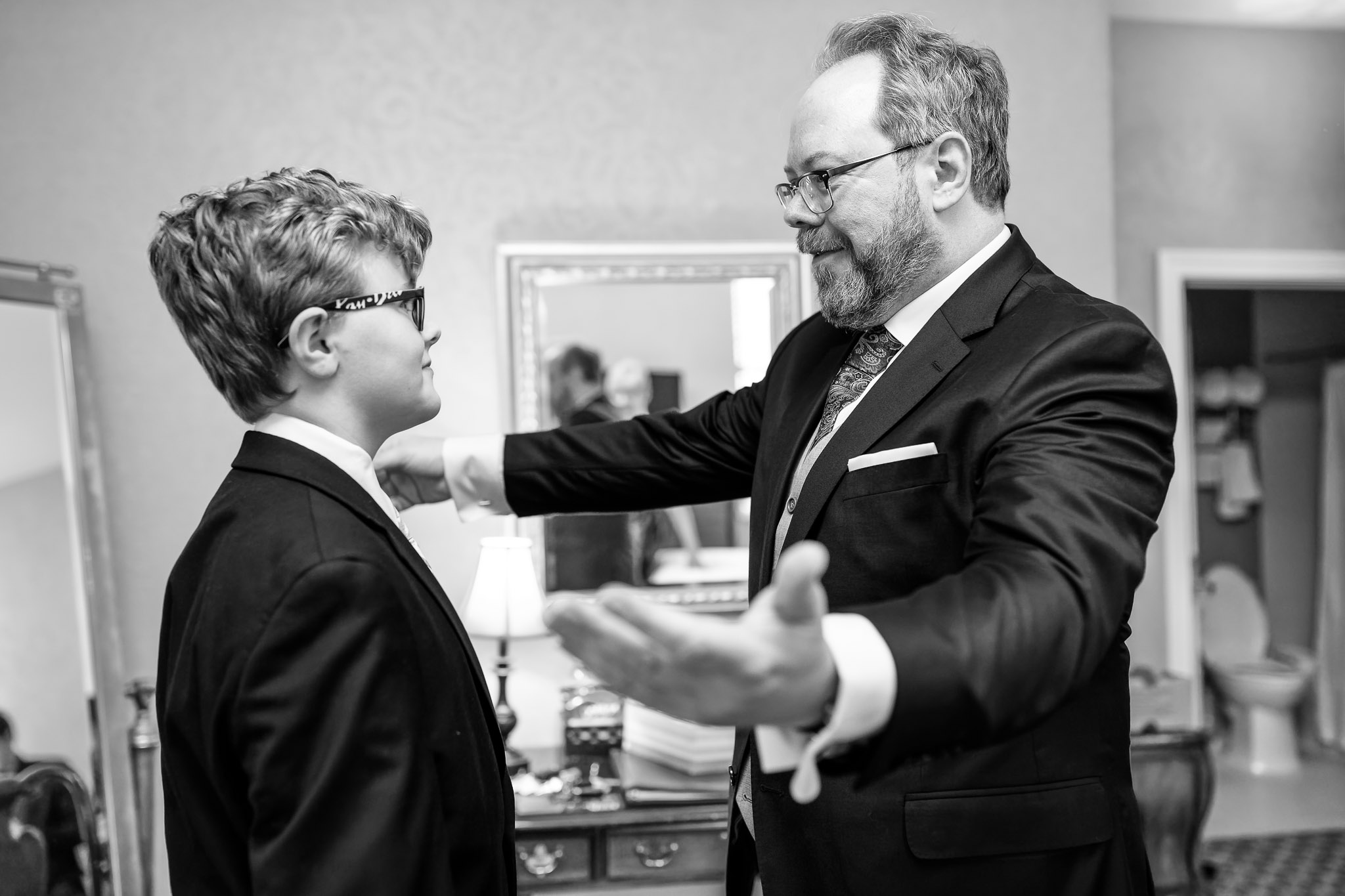 Father and Son Embrace During Wedding Ceremony