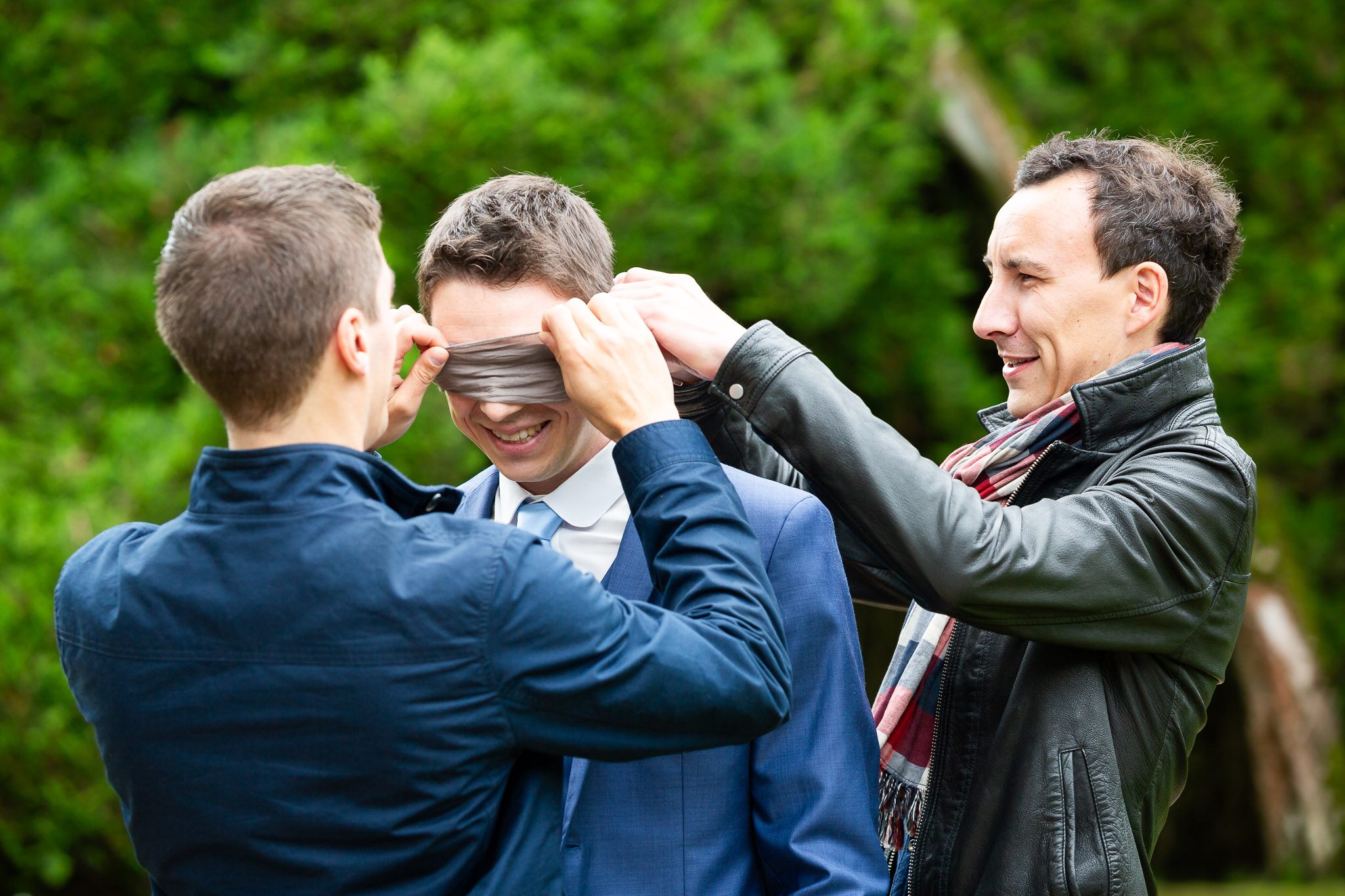 Groomsmen Cover Groom's Eyes Before First Look Wedding Moment