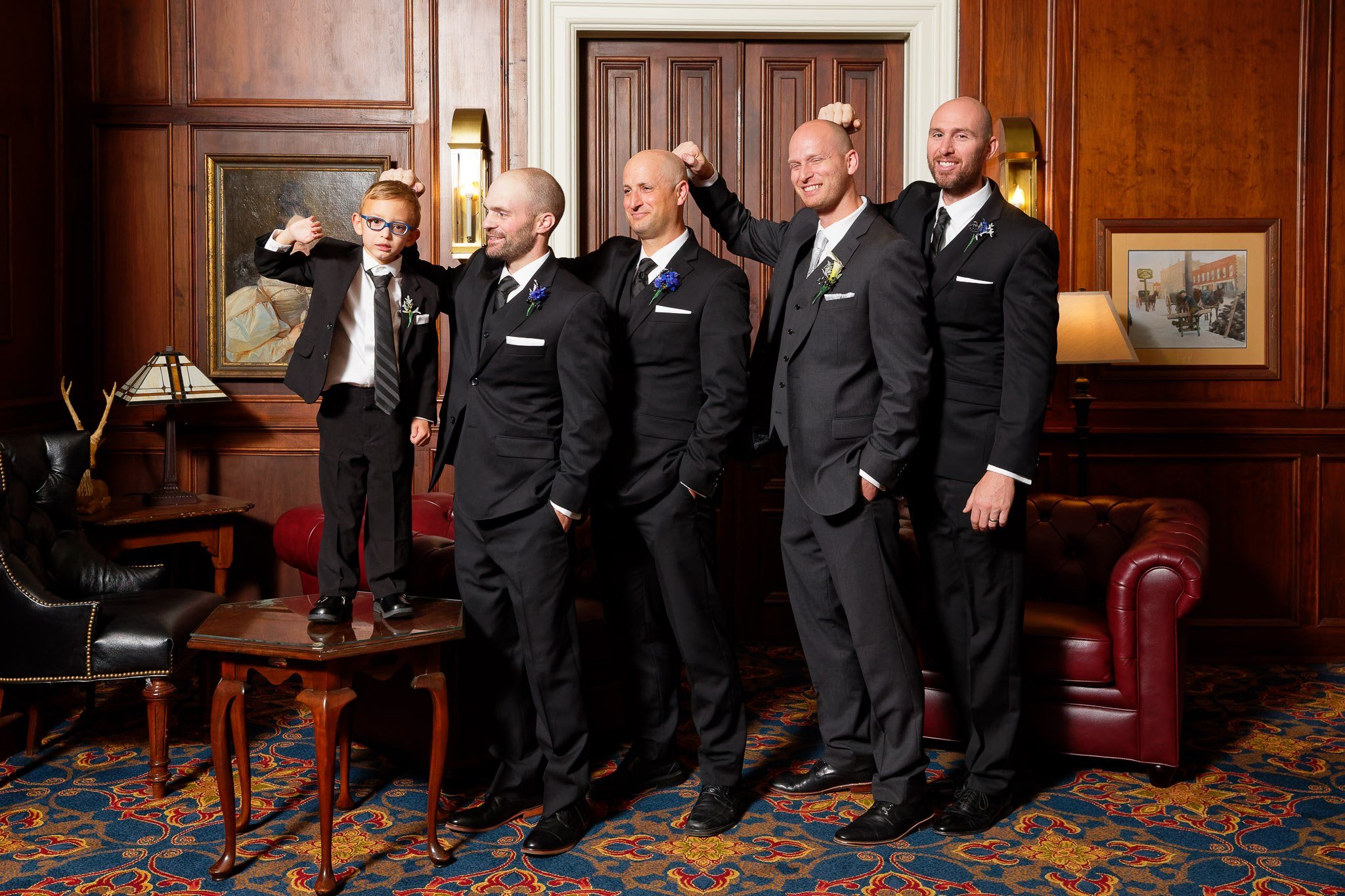Bold Groom's Party Flexing During Wedding Photos
