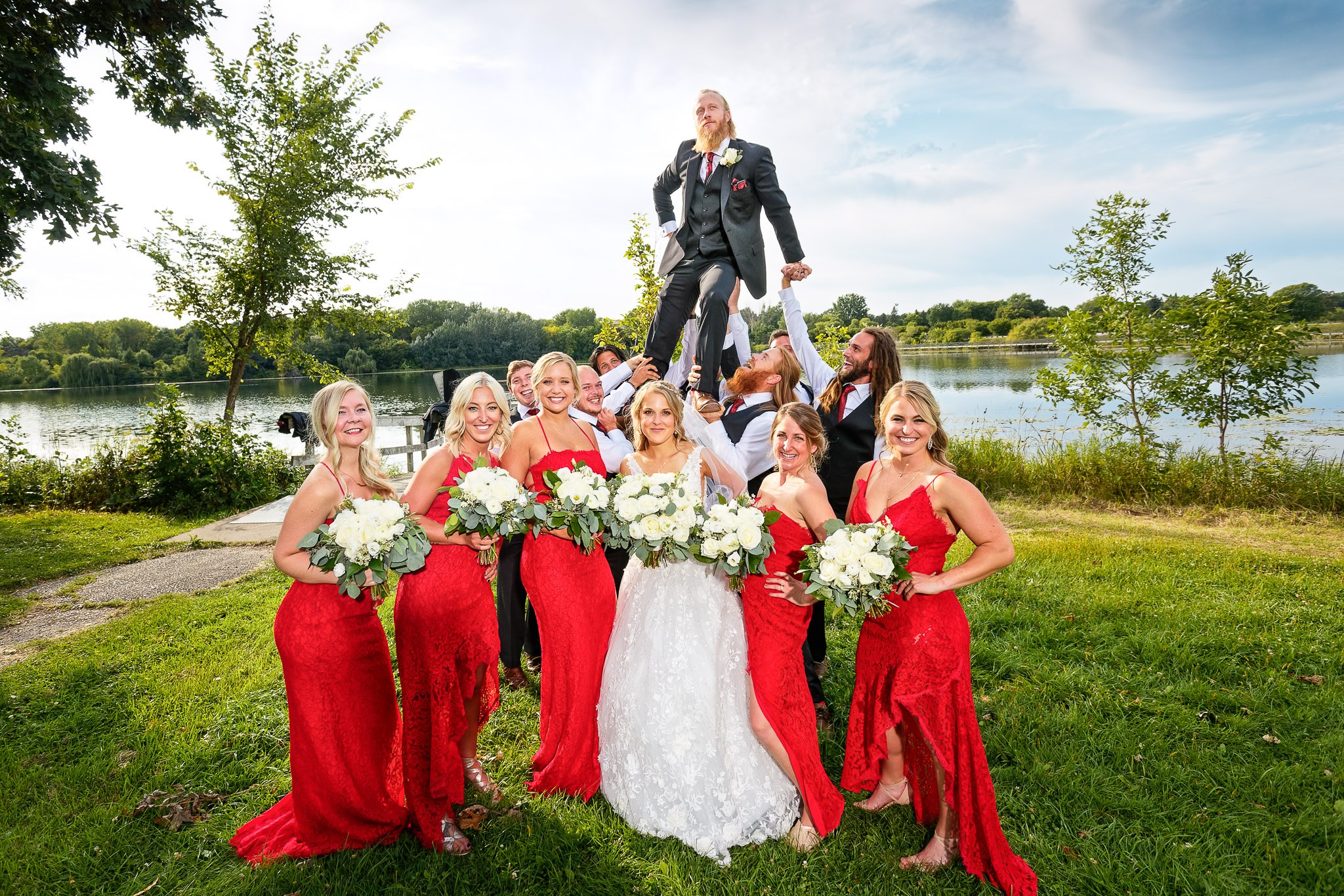 Hilarious Wedding Party Group Photo with Groom Lifted High