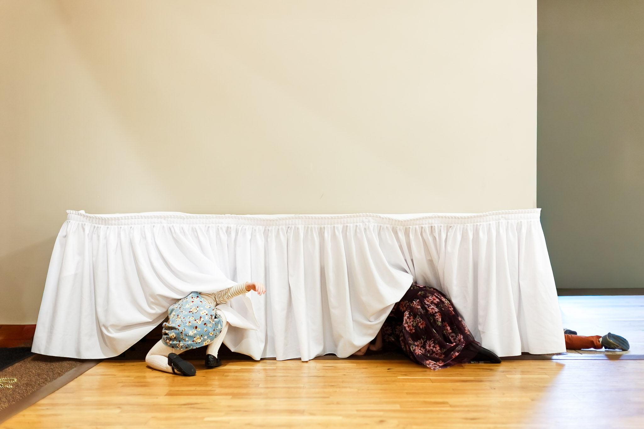 Kids Crawling Under Table Cloth Wedding Reception Moment