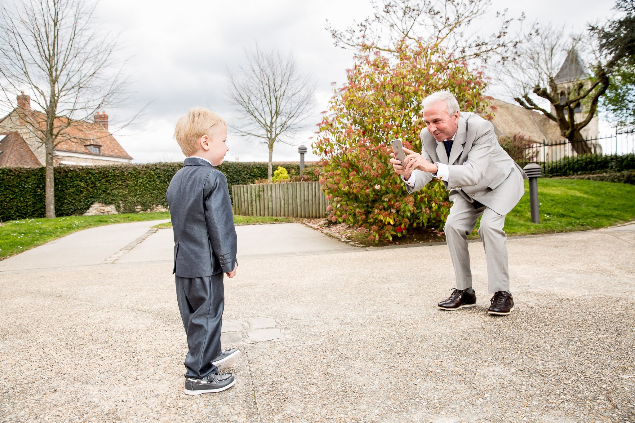 Grandfather Photographing Great Grandson at Wedding