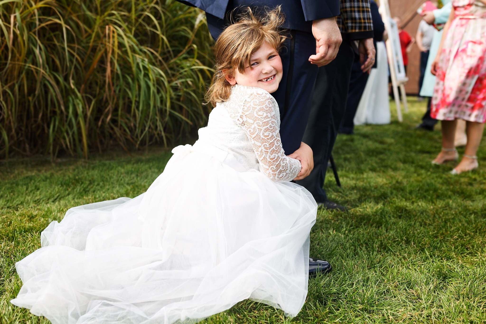 Child Hugging Groom During Cocktail Hour - Wisconsin Wedding
