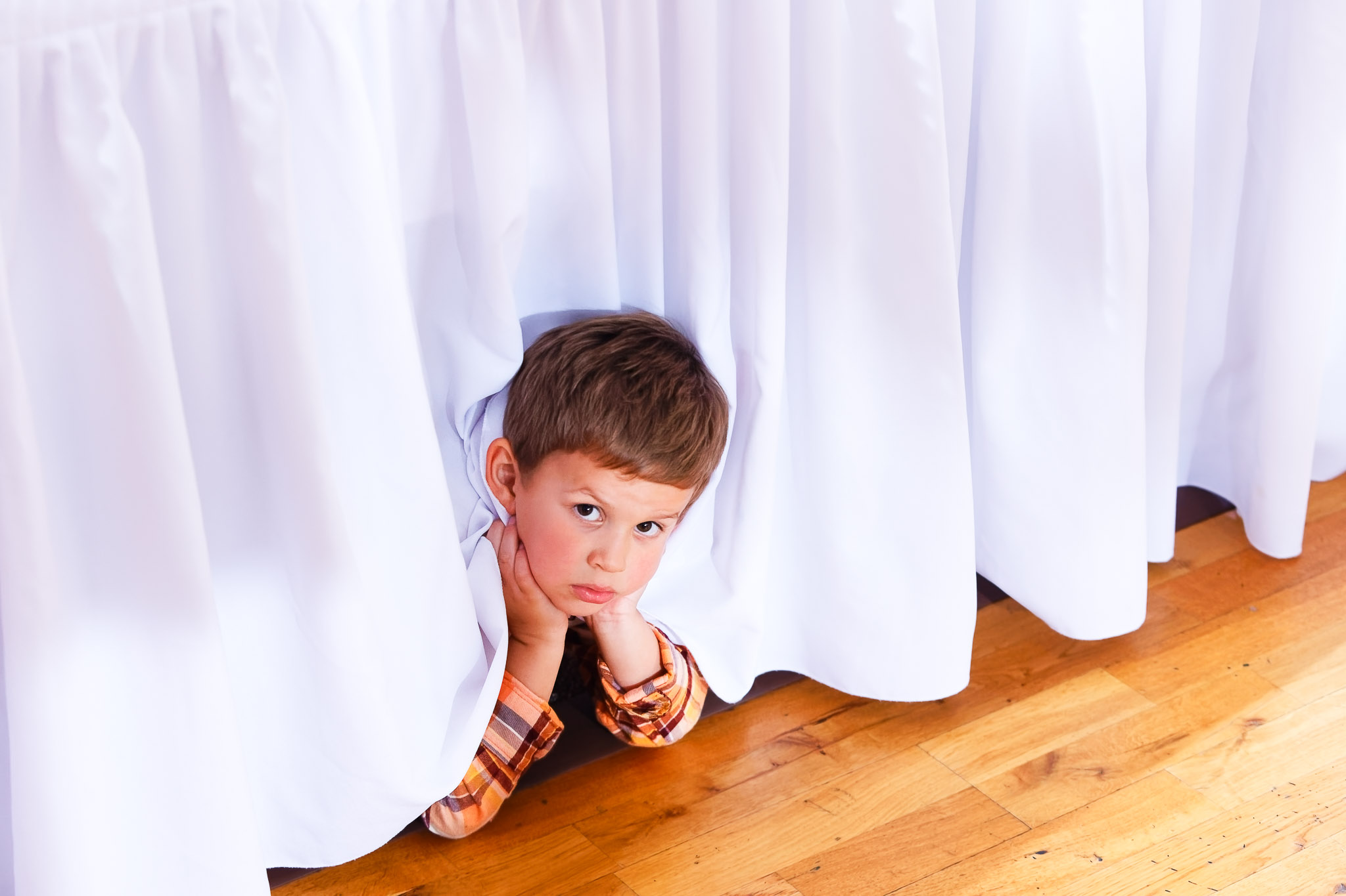 Child Playing Under Table at River Falls Wedding Reception