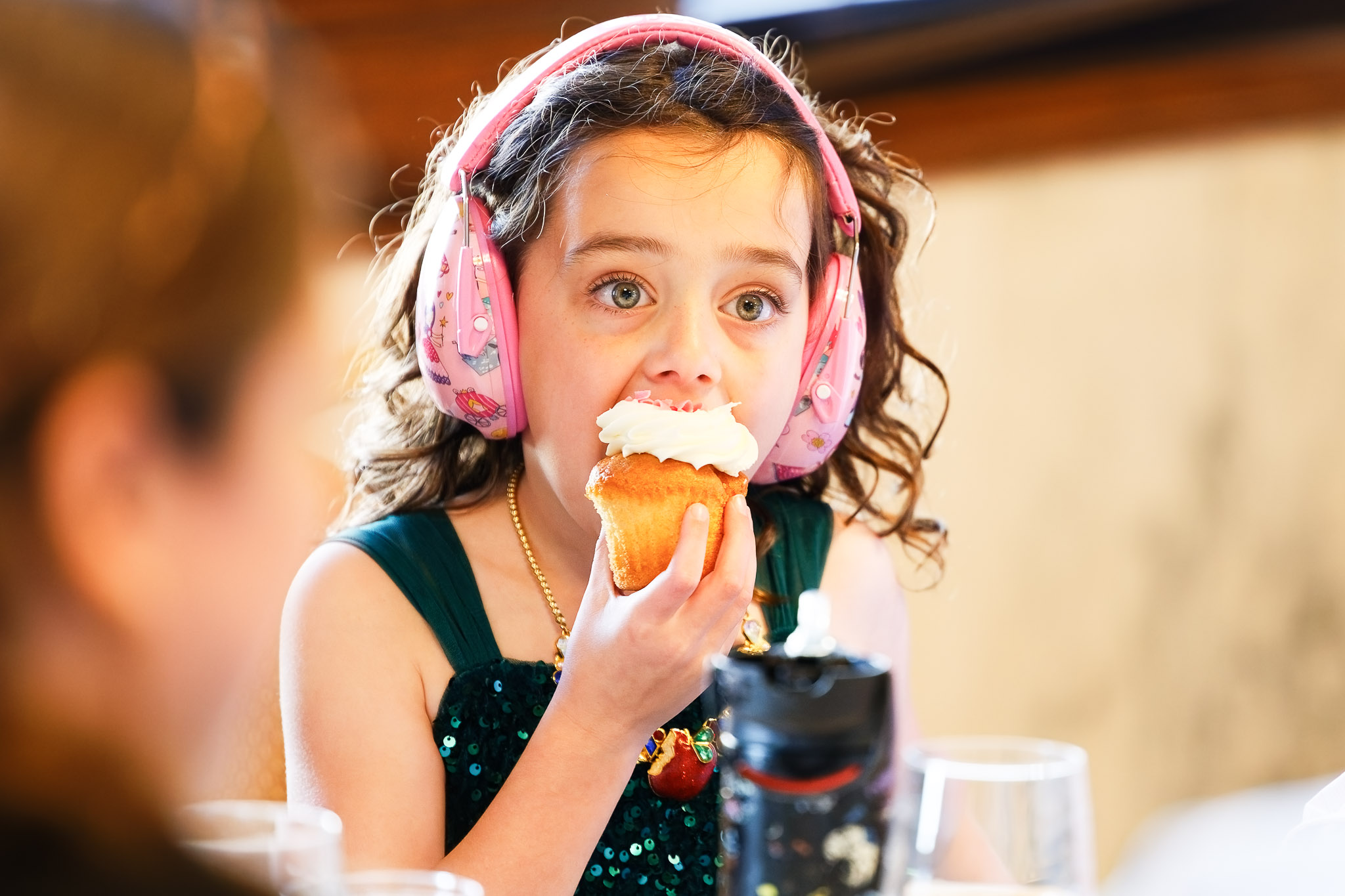 Girl with Headphones Eating Muffin at St. Paul Wedding