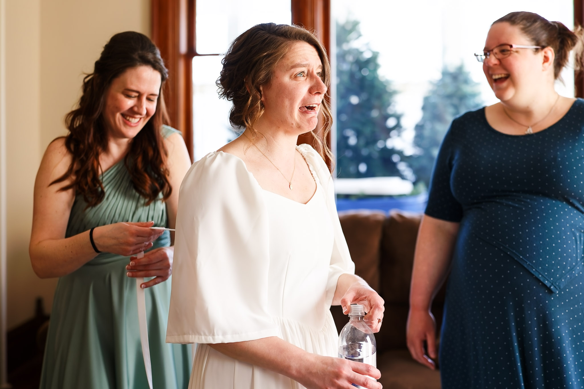 Stressed Bride and Laughing Sister Pre-Ceremony Moment