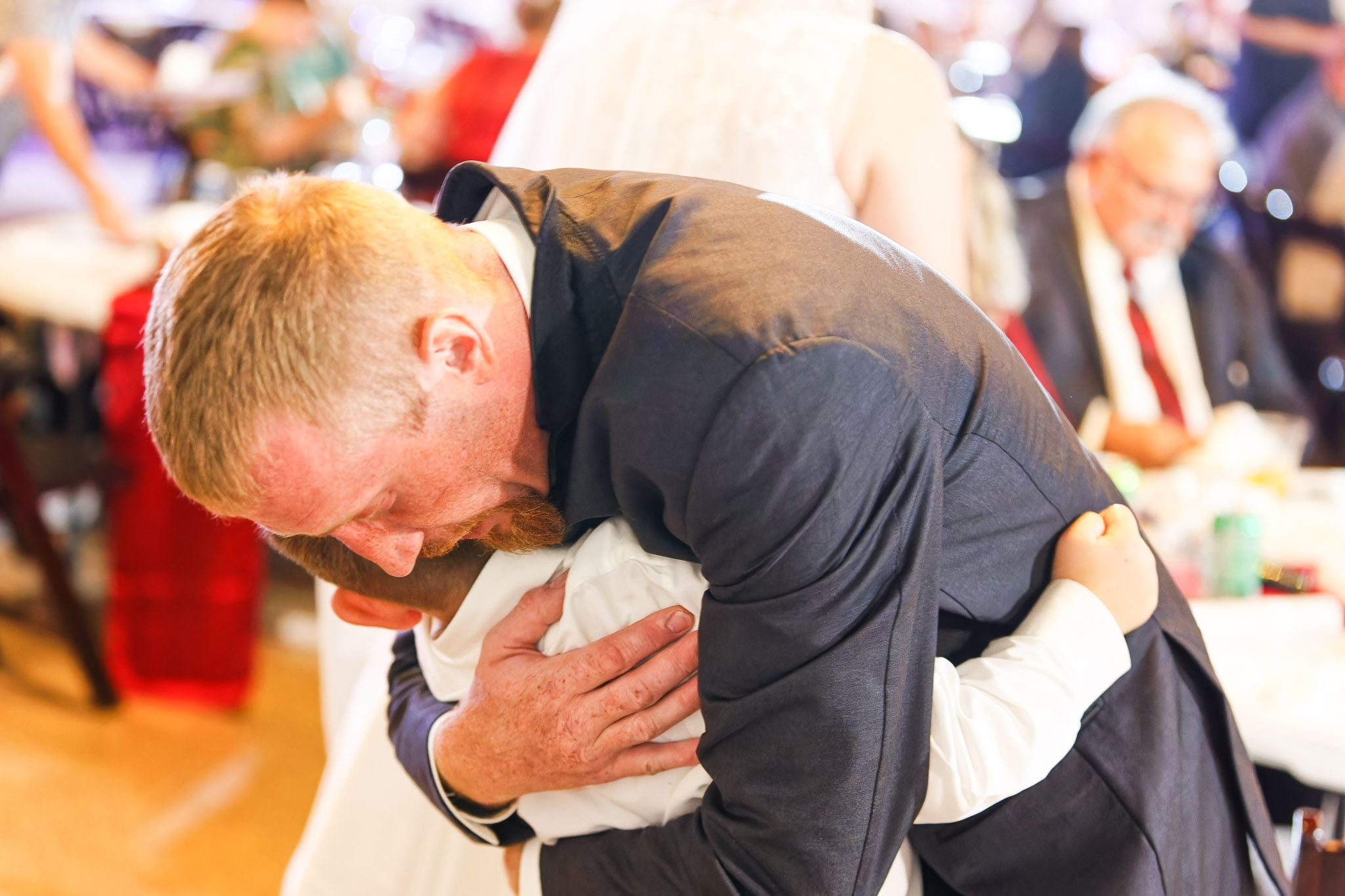 Bestman and Child Embrace at Blue Earth Wedding Reception