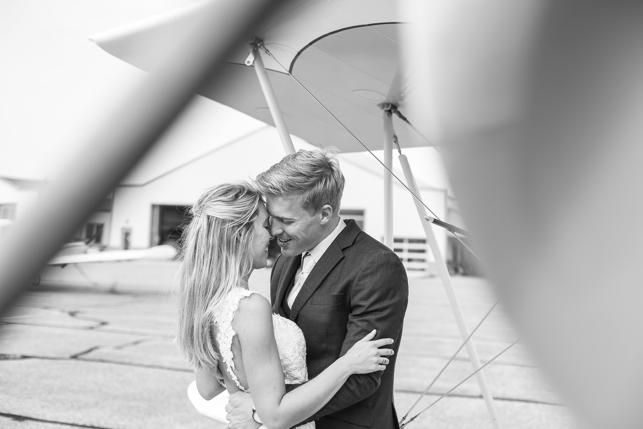 Bride and Groom Kiss Behind Vintage Biplane - Trash the Dress