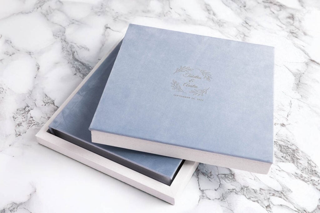 Customized Blue velvet wedding album with it's box, silver gliding, logo end pages